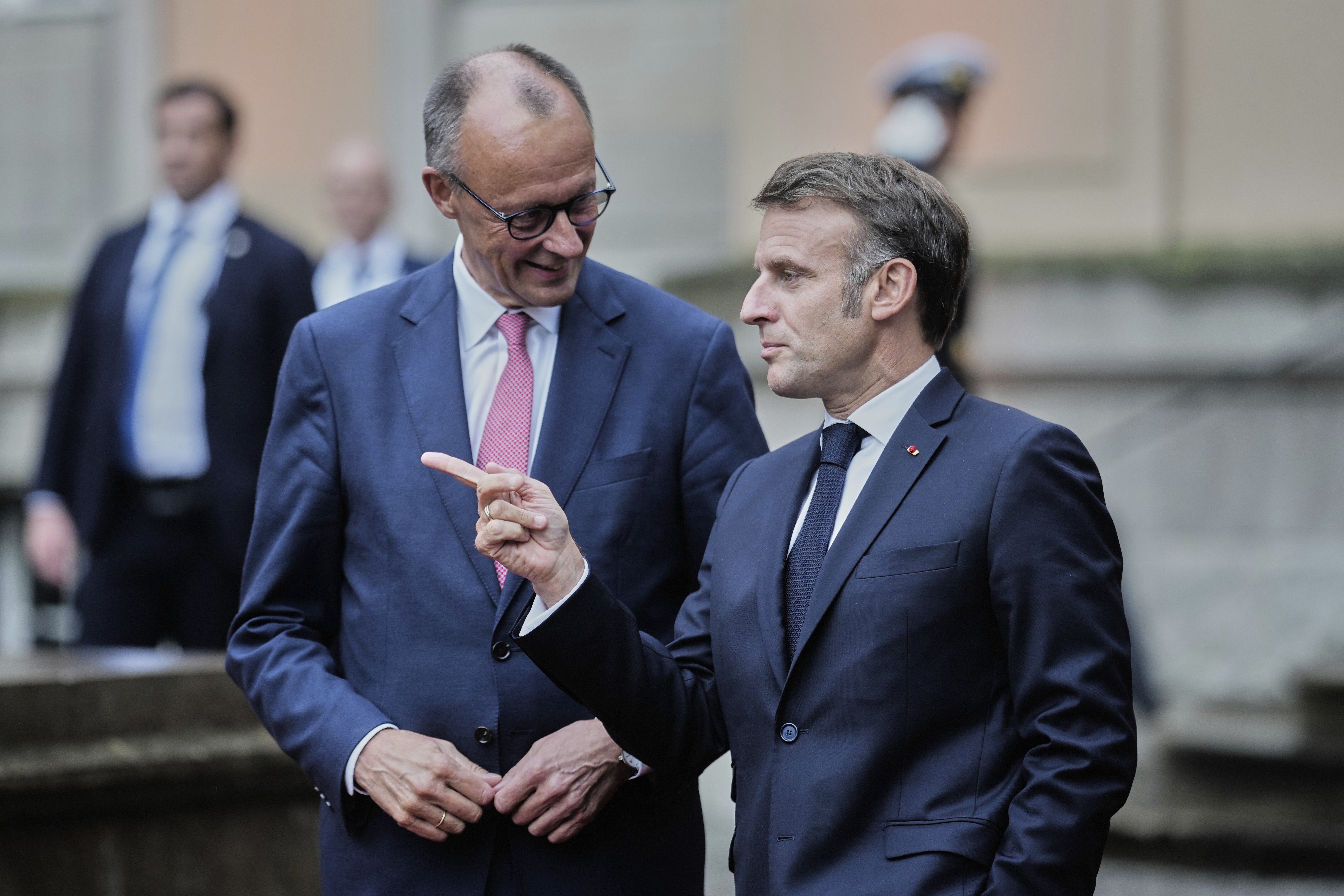 German Chancellor Friedrich Merz, left, welcomes French President Emmanuel Macron at the Foreign Ministry's guest house Villa Borsig in Berlin, Germany, Wednesday, July 23, 2025. (AP Photo/Markus Schreiber)