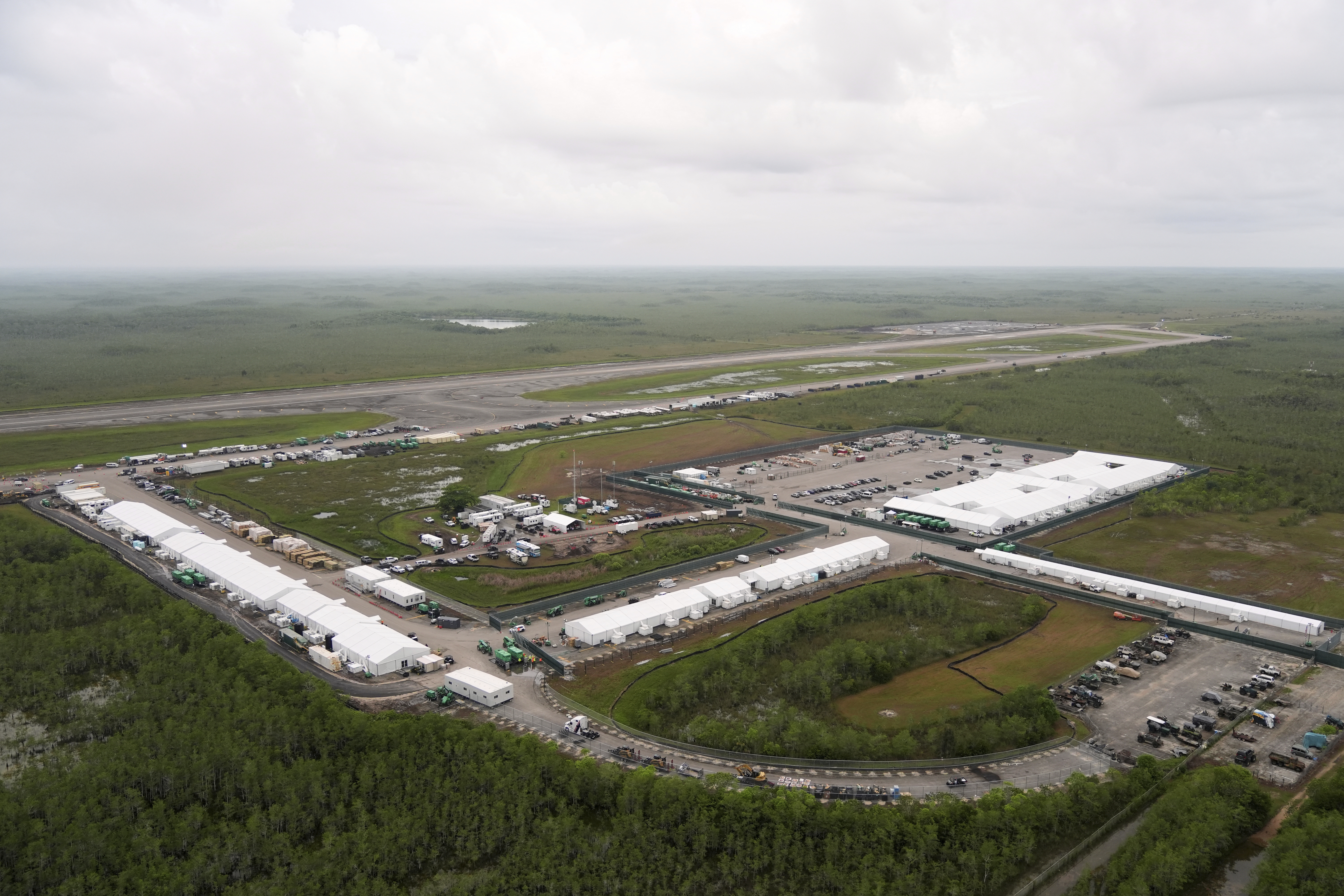 Work progresses on a new migrant detention facility dubbed "Alligator Alcatraz," at Dade-Collier Training and Transition facility in the Florida Everglades, Friday, July 4, 2025, in Ochopee, Fla. (AP Photo/Rebecca Blackwell)