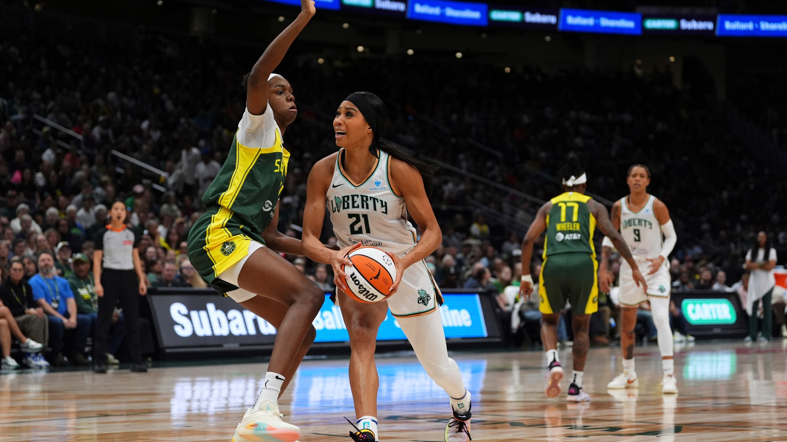 FILE - New York Liberty forward Isabelle Harrison (21) goes to the basket against Seattle Storm center Dominique Malonga, left, during a WNBA basketball game, June 22, 2025, in Seattle. (AP Photo/Lindsey Wasson, File)