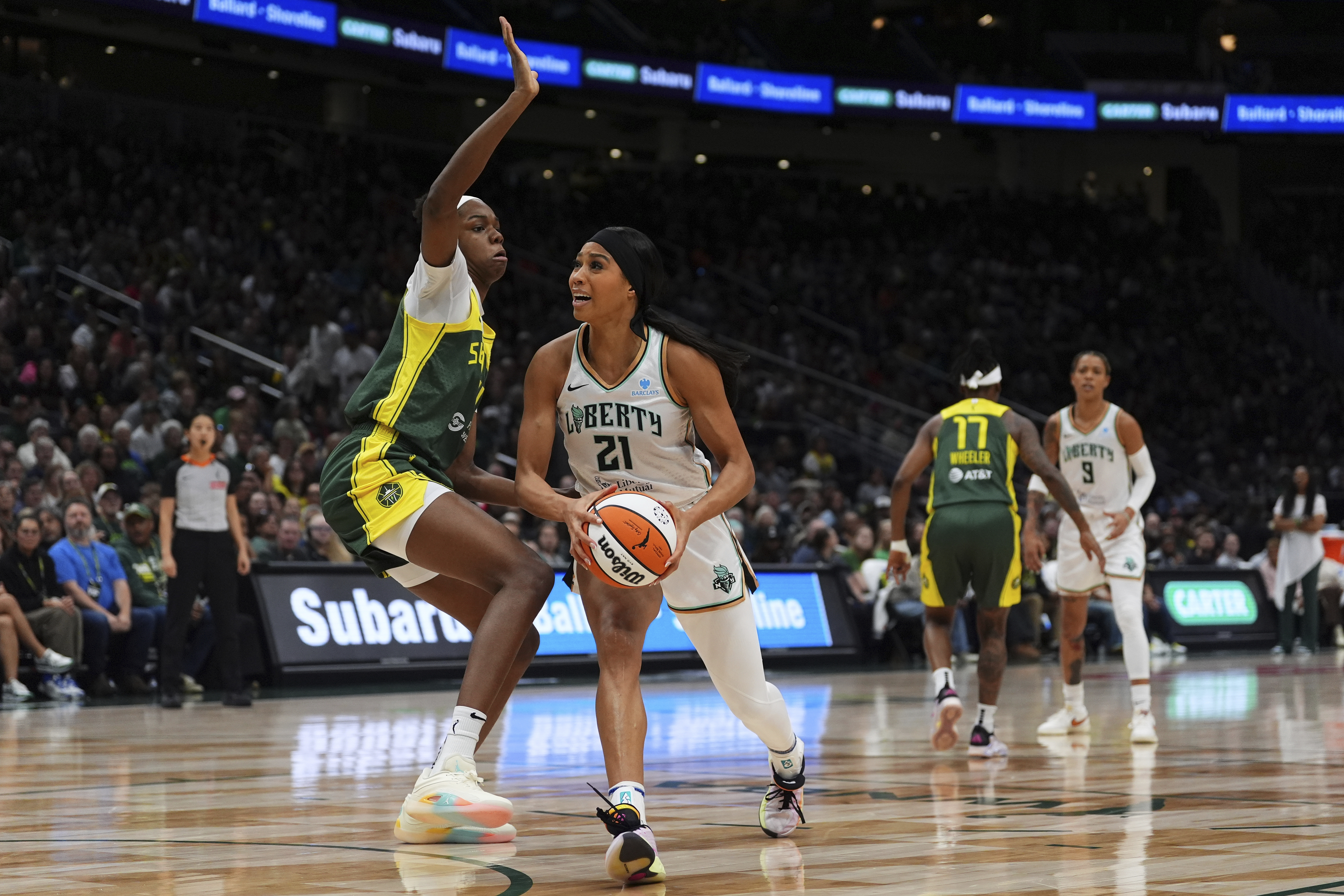 FILE - New York Liberty forward Isabelle Harrison (21) goes to the basket against Seattle Storm center Dominique Malonga, left, during a WNBA basketball game, June 22, 2025, in Seattle. (AP Photo/Lindsey Wasson, File)