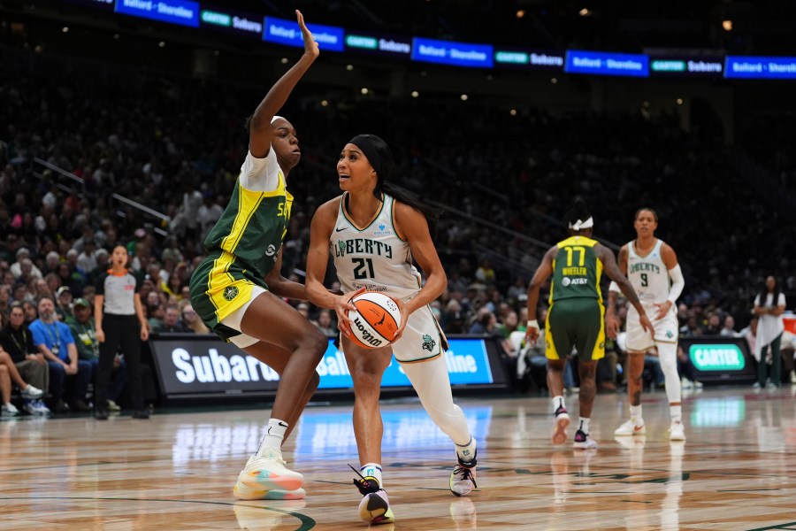 FILE - New York Liberty forward Isabelle Harrison (21) goes to the basket against Seattle Storm center Dominique Malonga, left, during a WNBA basketball game, June 22, 2025, in Seattle. (AP Photo/Lindsey Wasson, File)