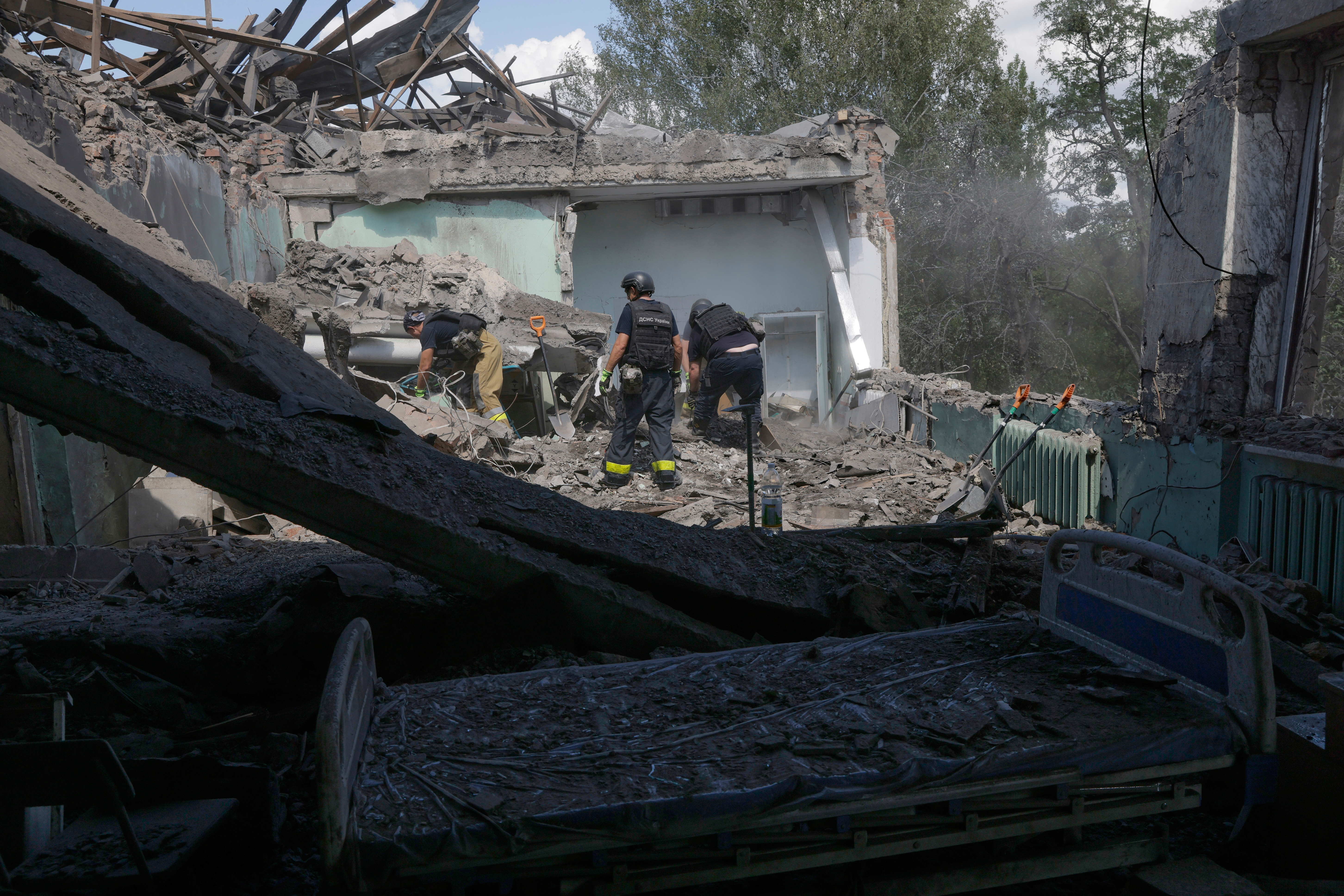 Rescuers clear the rubble after a Russian guided air bomb hit a city hospital in Kharkiv, Ukraine, Friday, July 25, 2025. (AP Photo/Yevhen Titov)