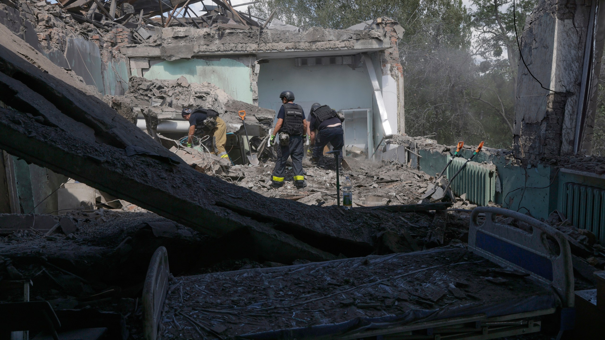 Rescuers clear the rubble after a Russian guided air bomb hit a city hospital in Kharkiv, Ukraine, Friday, July 25, 2025. (AP Photo/Yevhen Titov)