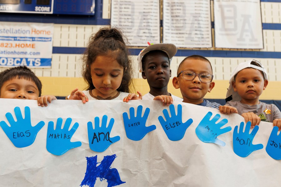 LASOS summer campers hold up an art project at Bel Air High School in Bel Air, Md., on Thursday, July 24, 2025. (AP Photo/KT Kanazawich)