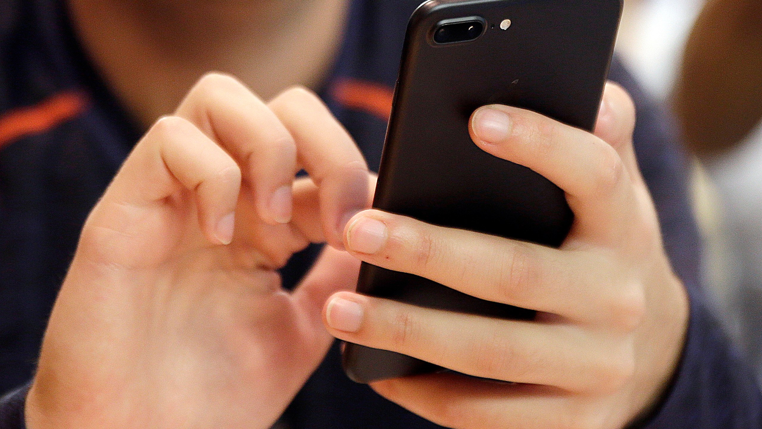 FILE - A person uses a smartphone in Chicago, Sept. 16, 2017. (AP Photo, File)
