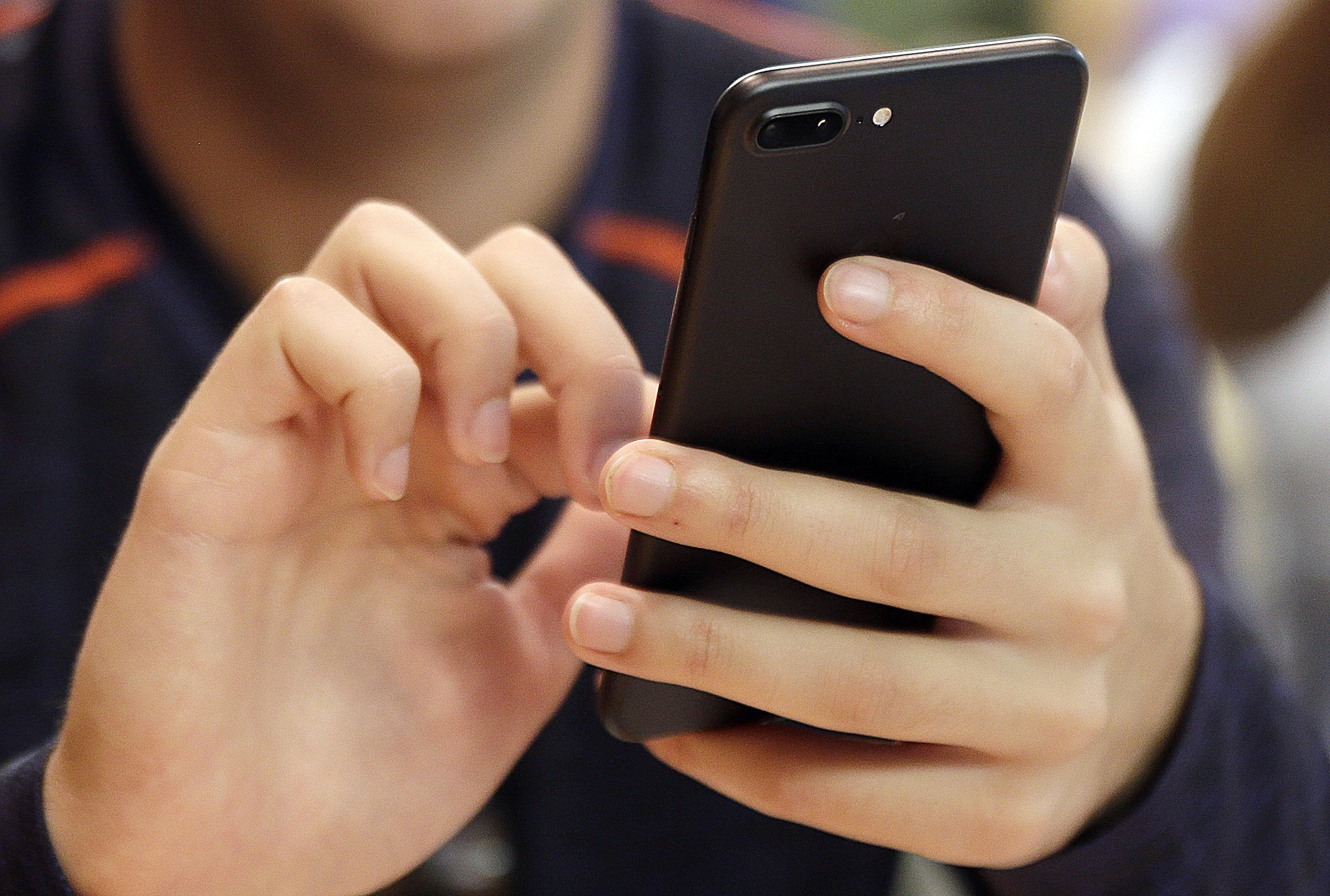 FILE - A person uses a smartphone in Chicago, Sept. 16, 2017. (AP Photo, File)