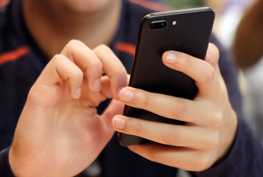 FILE - A person uses a smartphone in Chicago, Sept. 16, 2017. (AP Photo, File)