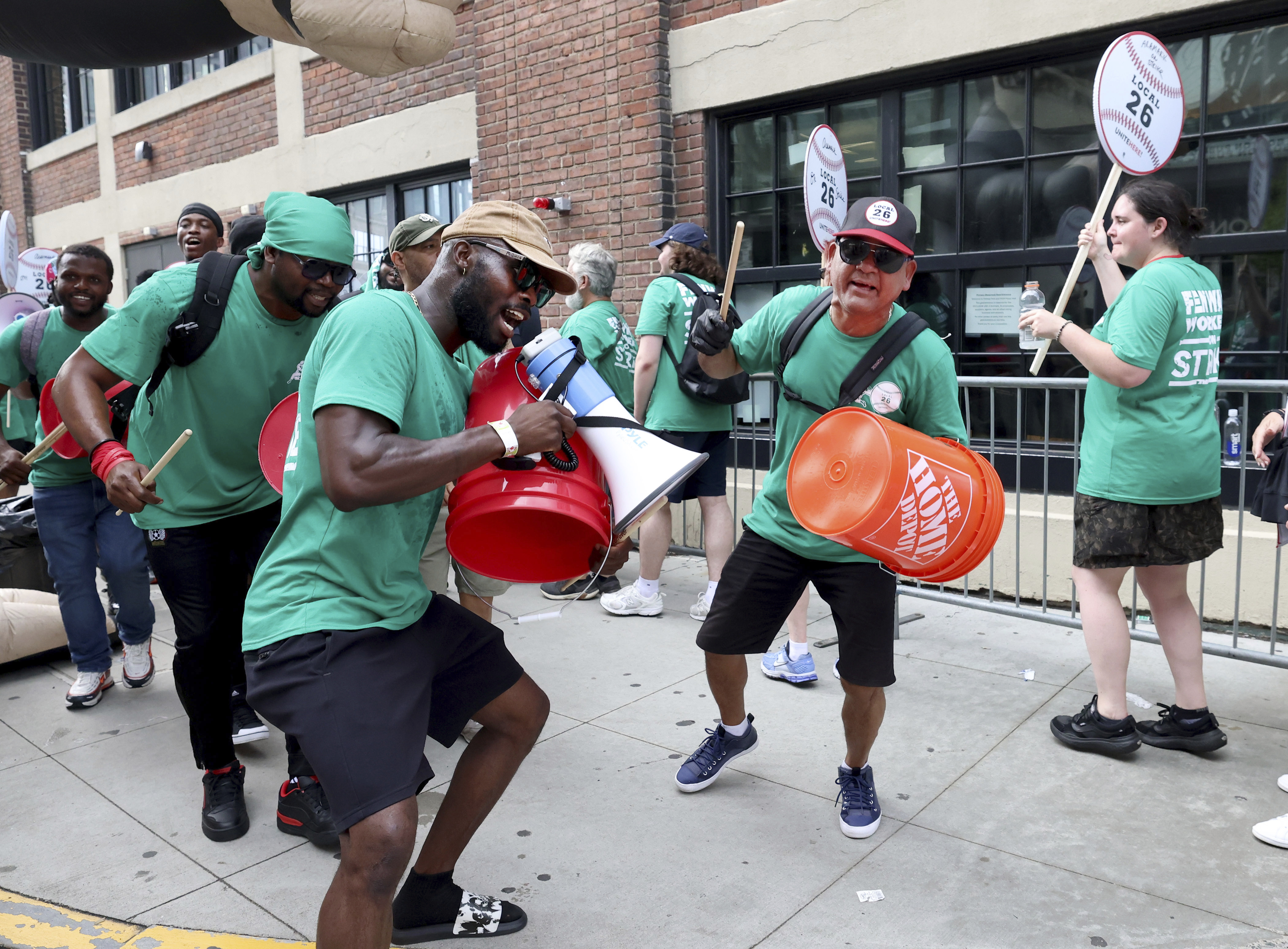 Concession workers from Fenway Park picket outside the ballpark Friday, July 25, 2025, in Boston before a baseball game between the Boston Red Sox and the Los Angeles Dodgers. (AP Photo/Mark Stockwell)