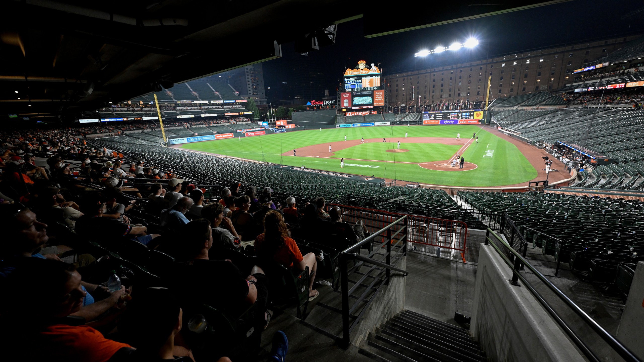 Fans have vacated the lower bowl during a thunderstorm in the seventh inning of a baseball game between the Baltimore Orioles and the Colorado Rockies in Baltimore, Friday, July 25, 2025. (AP Photo/Terrance Williams)