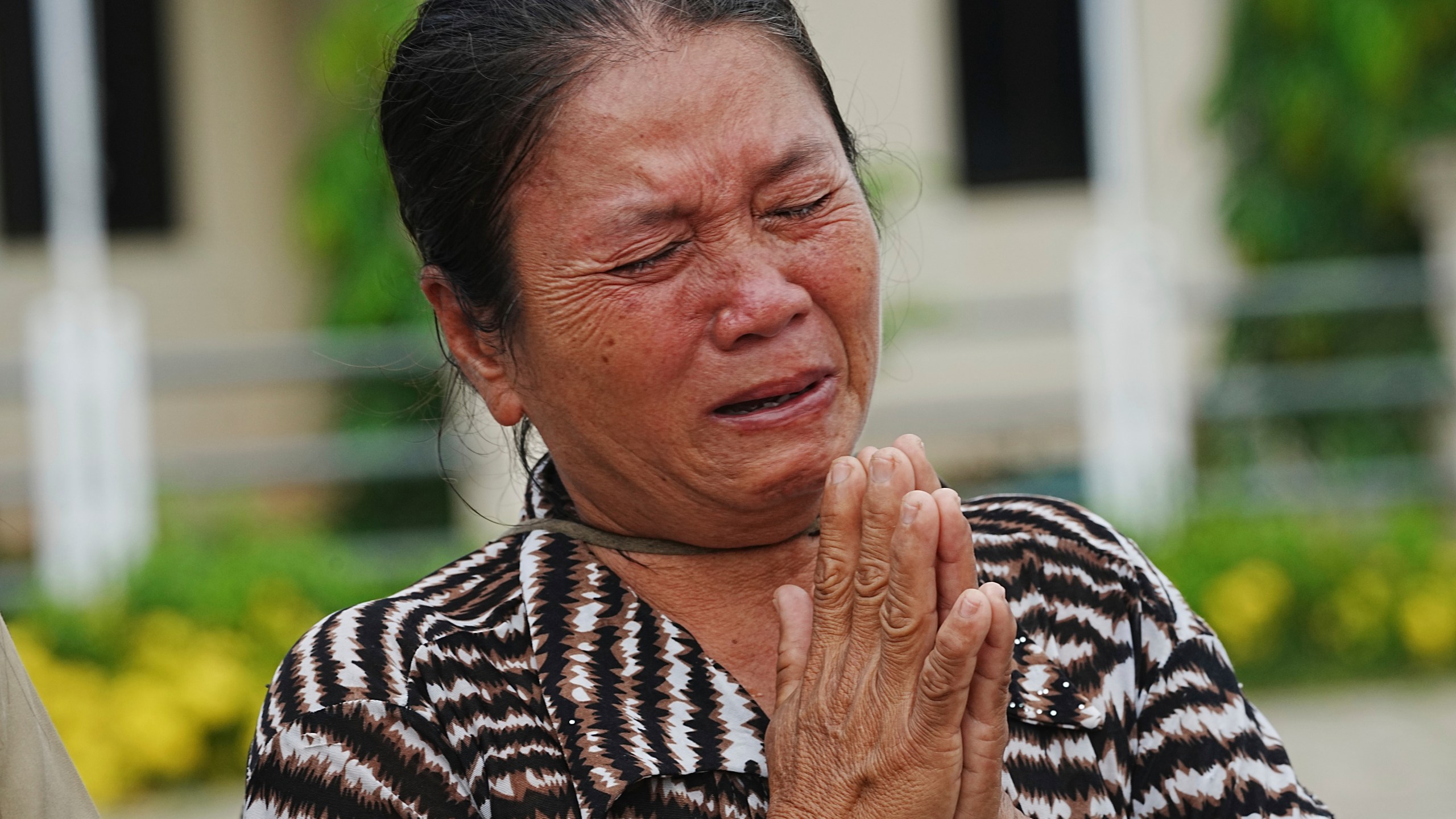 A local villager weeps as she donates her personal belongings for the frontline army force at a sidewalk in Srey Snam district in Siem Reap province, Cambodia, Saturday, July 26, 2025. (AP Photo/Heng Sinith)
