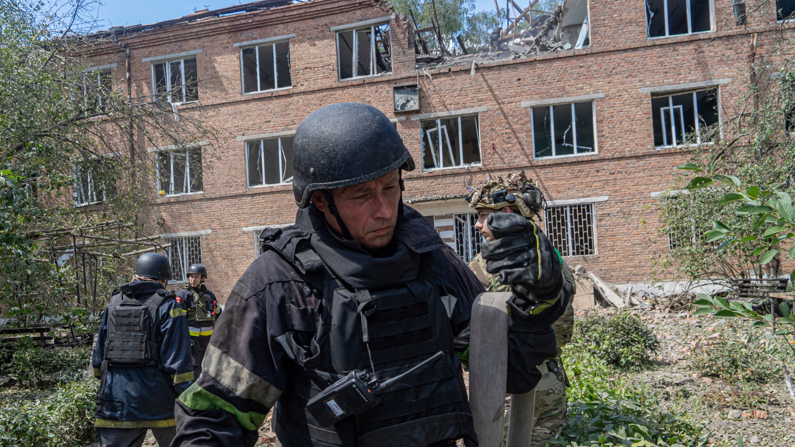 Rescuers work at a damaged city hospital that was hit by a Russian guided air bomb in Kharkiv, Ukraine, Friday, July 25, 2025. (AP Photo/Andrii Marienko)