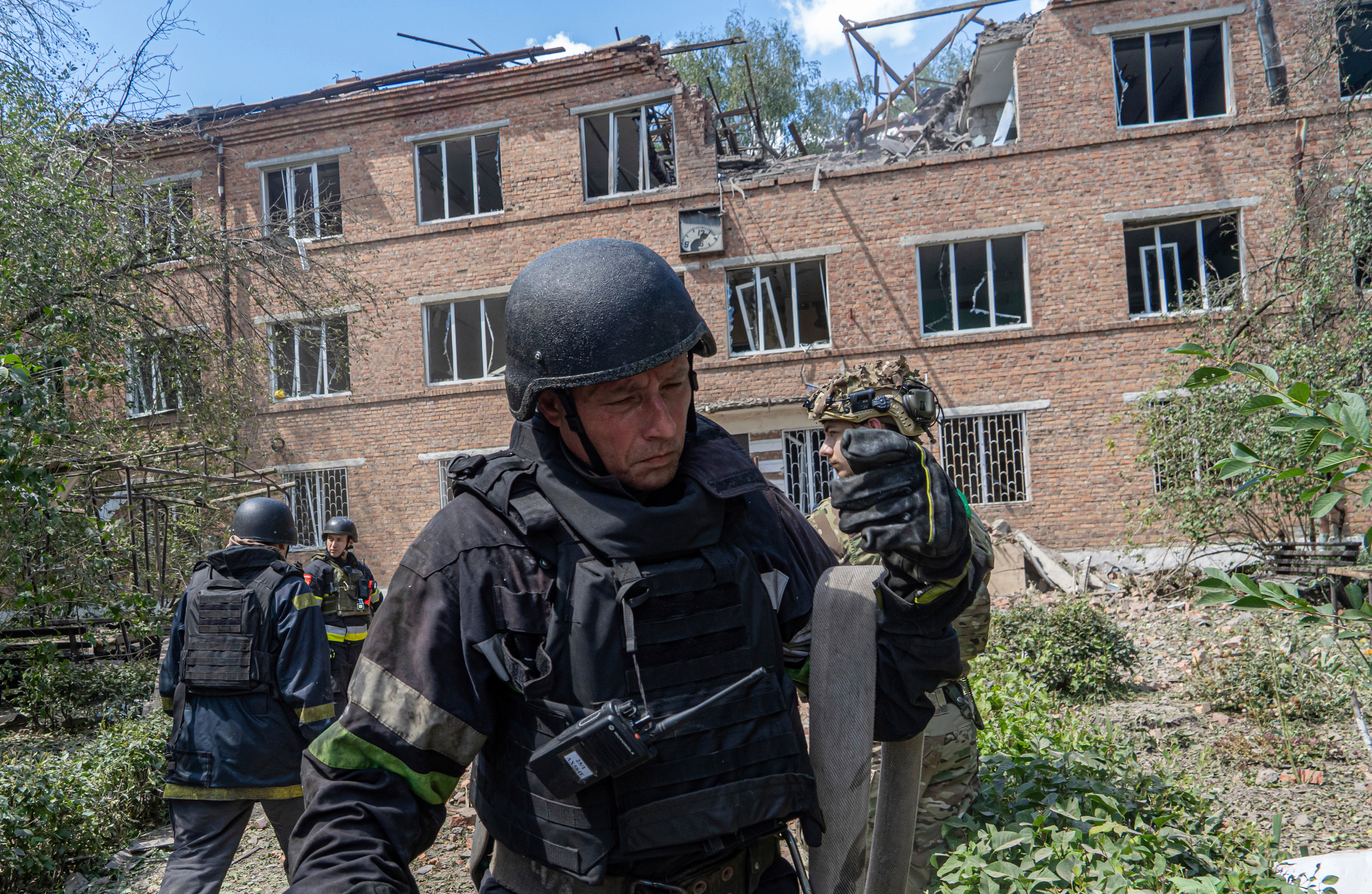 Rescuers work at a damaged city hospital that was hit by a Russian guided air bomb in Kharkiv, Ukraine, Friday, July 25, 2025. (AP Photo/Andrii Marienko)