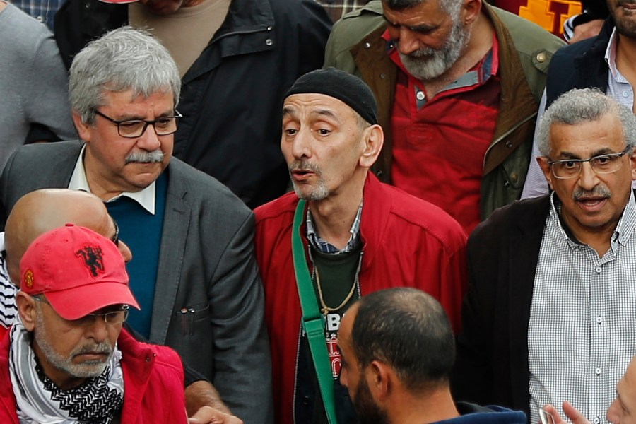 Ziad Rahbani, centre, a visionary Lebanese composer, playwright and pianist, during an anti-government protest organized by the country's communist party, in Beirut, Lebanon, Sunday, Dec. 16, 2018. (AP Photo/Hussein Malla)