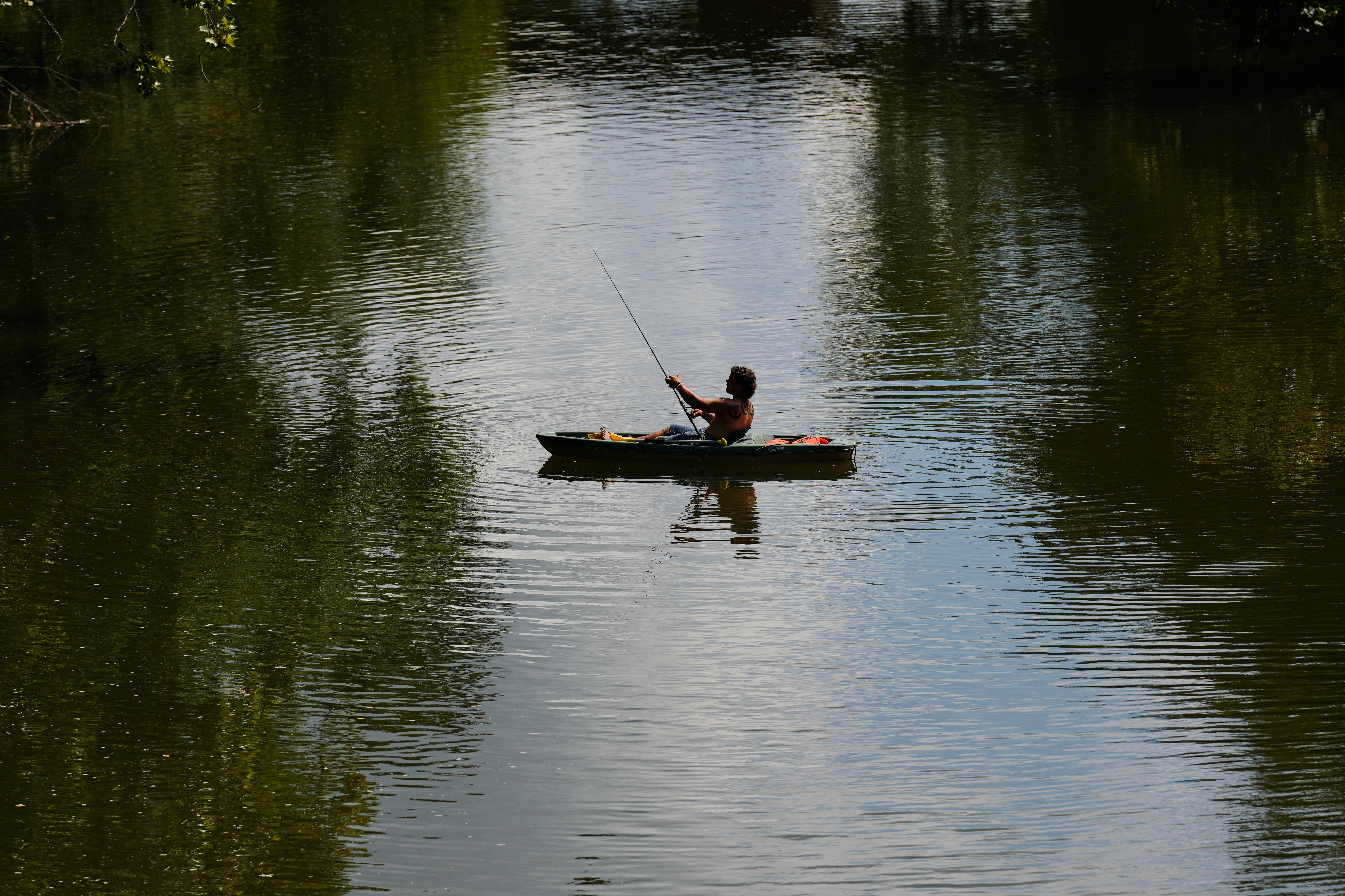 A person kayaks along the Stones River during a heat advisory, Friday, July 25, 2025, in Murfreesboro, Tenn. (AP Photo/George Walker IV)