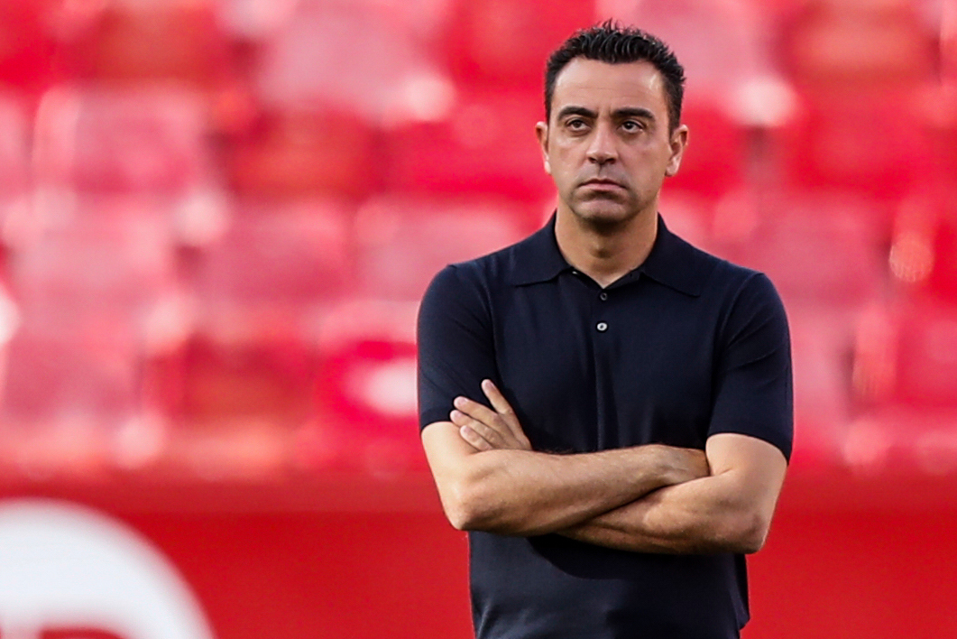 FILE - Barcelona's head coach Xavi Hernandez watches before the Spanish La Liga soccer match between Sevilla and FC Barcelona at the Ramon Sanchez Pizjuan stadium in Seville, Spain, Sunday, May 26, 2024. (AP Photo/Fermin Rodriguez, File)