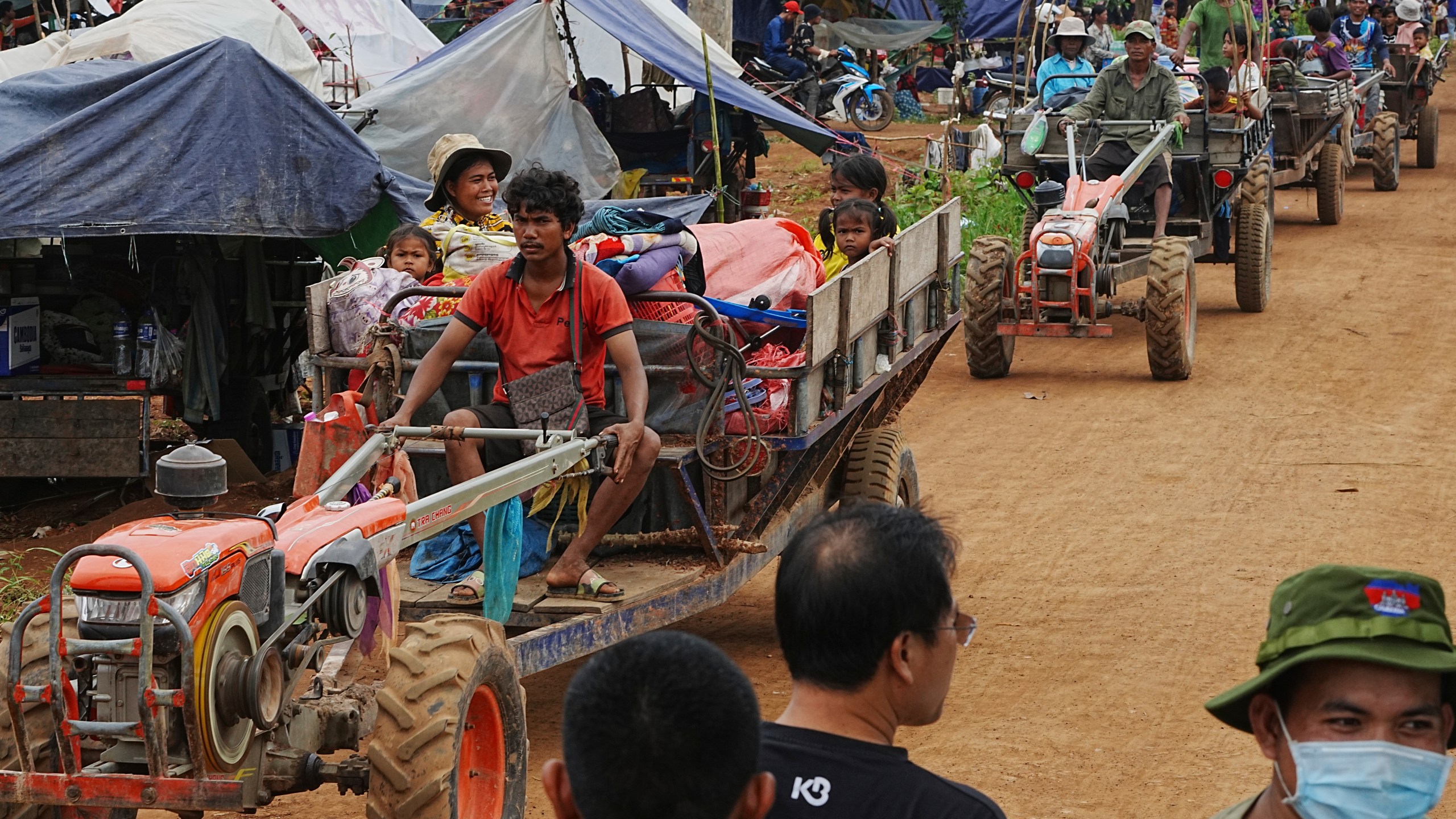 Cambodians sit on a cart of tractor as they take refuge in Batthkoa primary school in Oddar Meanchey province, Cambodia, Saturday, July 26, 2025, as border fighting between Thailand and Cambodia entered its third day. (AP Photo/Heng Sinith)