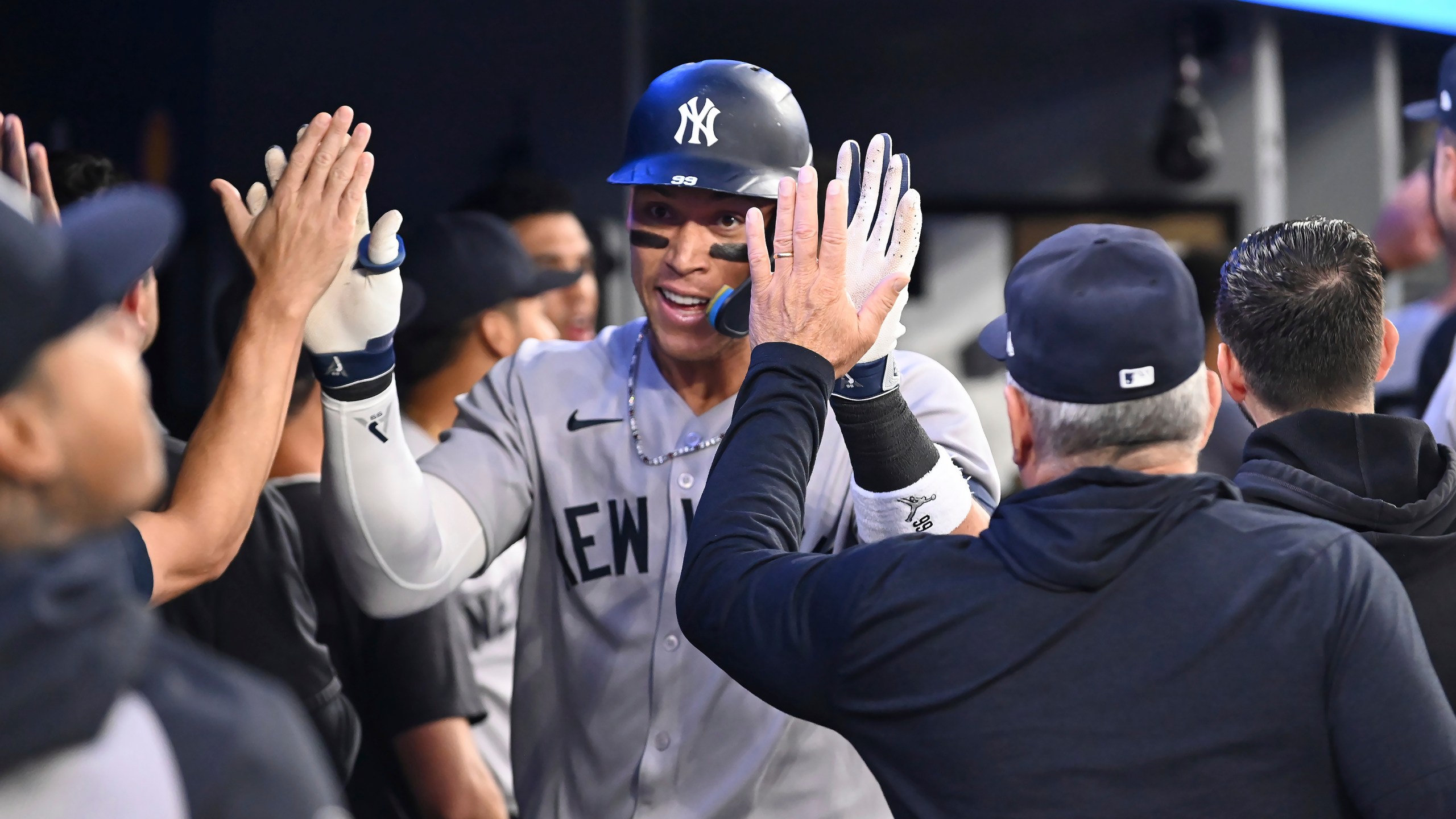 New York Yankees' Aaron Judge (99) celebrates in the dugout after hitting a two-run home run against the Toronto Blue Jays in the sixth inning of a baseball game in Toronto on Wednesday, July 23, 2025. (Jon Blacker/The Canadian Press via AP)