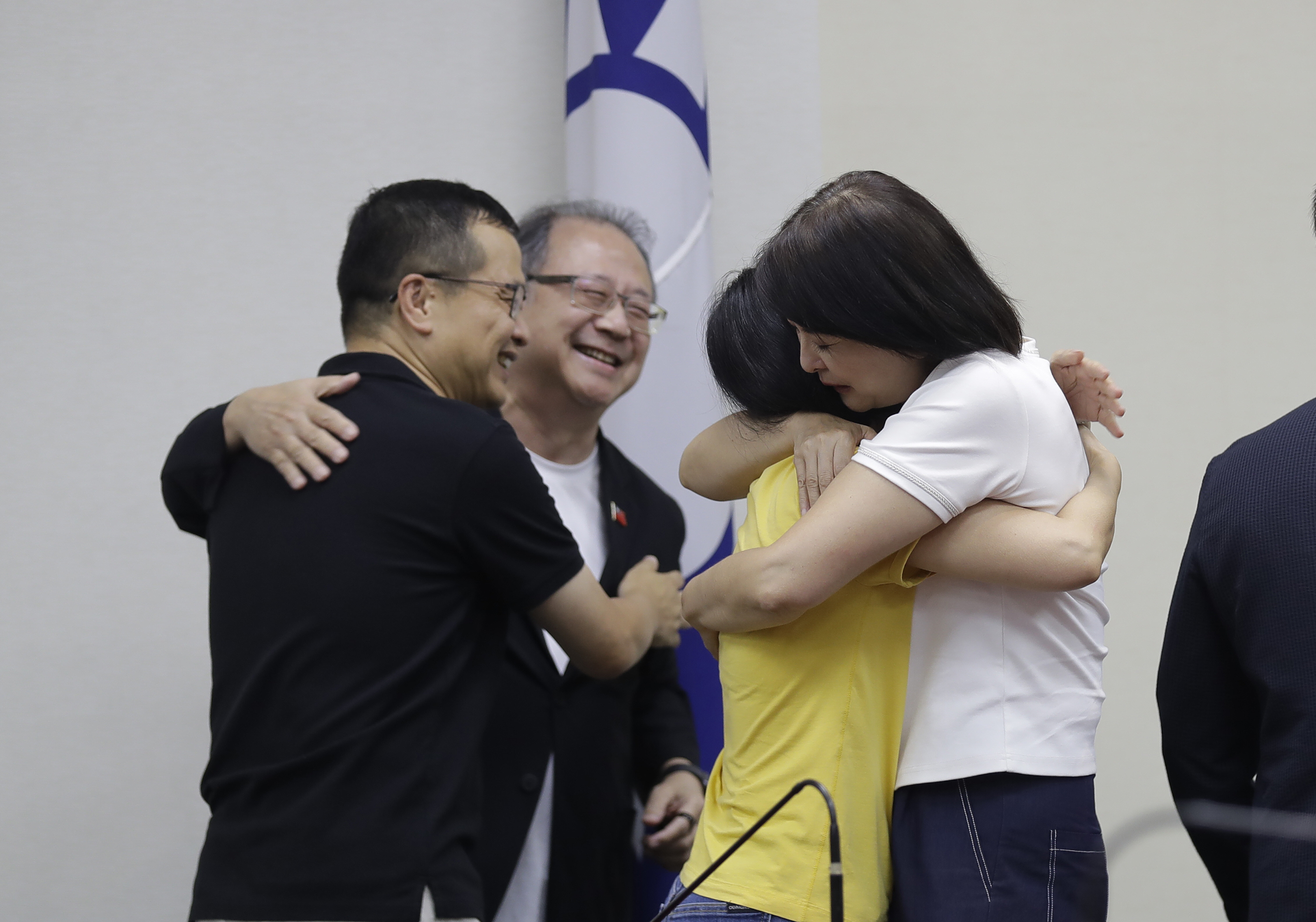 Lawmakers of Taiwan Opposition Nationalist Party and party staff cheer after a press conference in Taipei, Taiwan, Saturday, July 26, 2025. (AP Photo/Chiang Ying-ying)