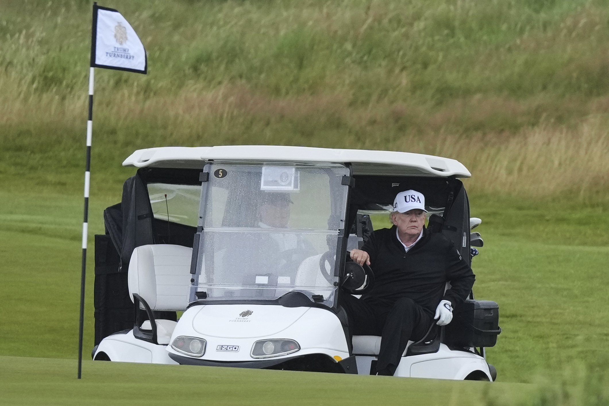 President Donald Trump steers a golf cart at the Trump Turnberry golf course in Turnberry, Scotland, Saturday, July 26, 2025.(AP Photo/Alastair Grant)