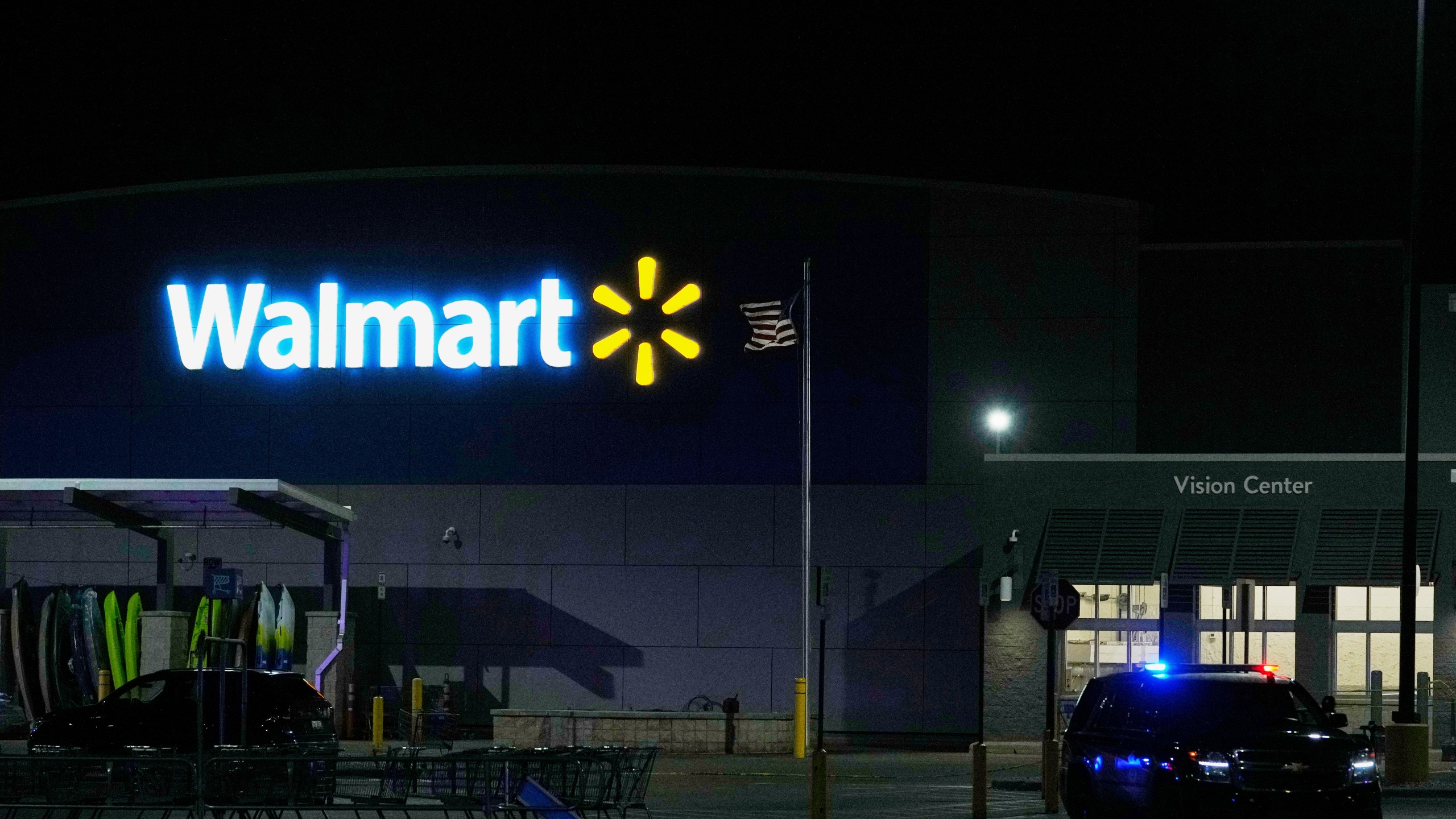 Law enforcement officers are seen stationed outside a Walmart where 11 people were stabbed in a violent attack Saturday, July 26, 2025, in Traverse City, Mich (AP Photo/Ryan Sun)