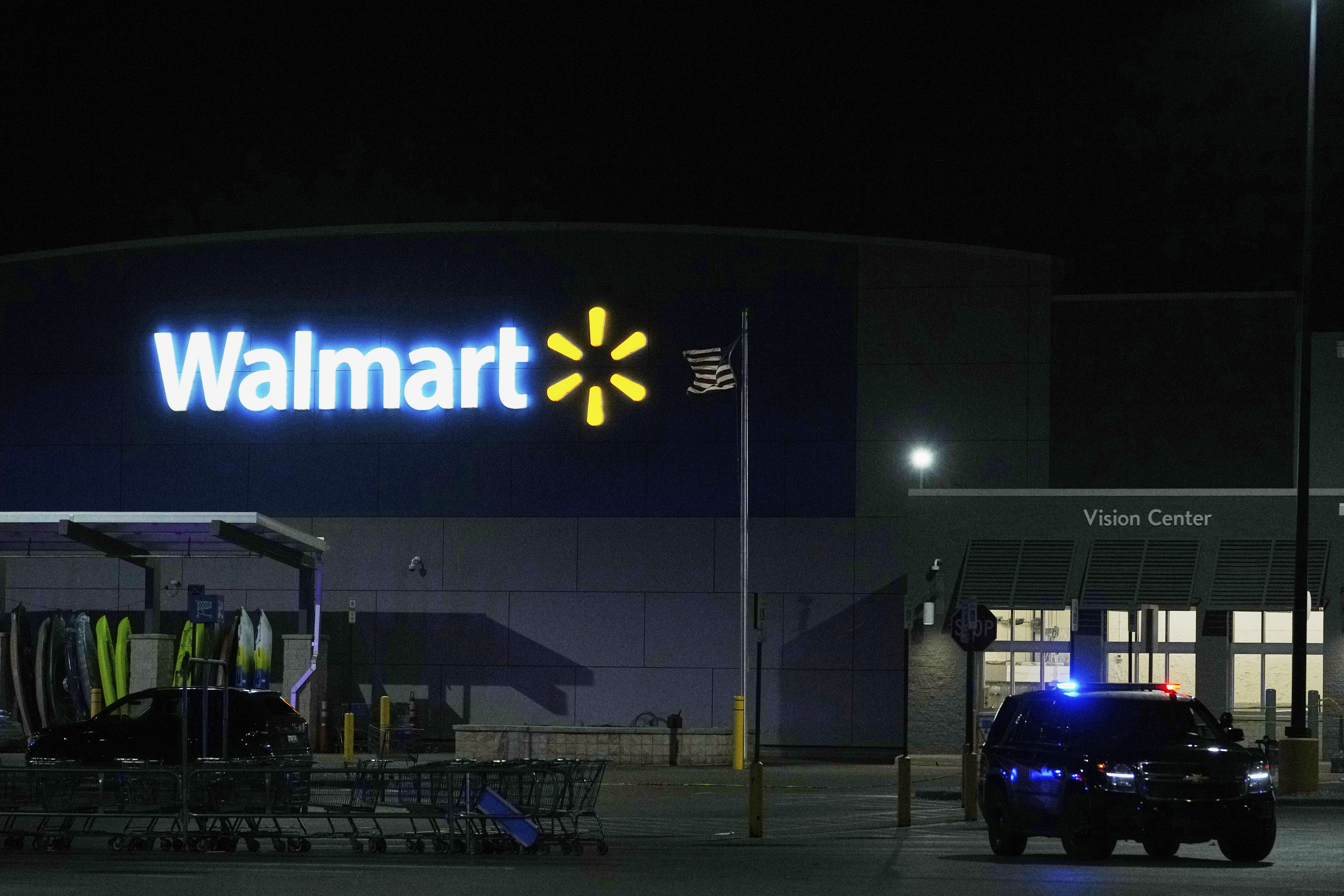 Law enforcement officers are seen stationed outside a Walmart where 11 people were stabbed in a violent attack Saturday, July 26, 2025, in Traverse City, Mich (AP Photo/Ryan Sun)