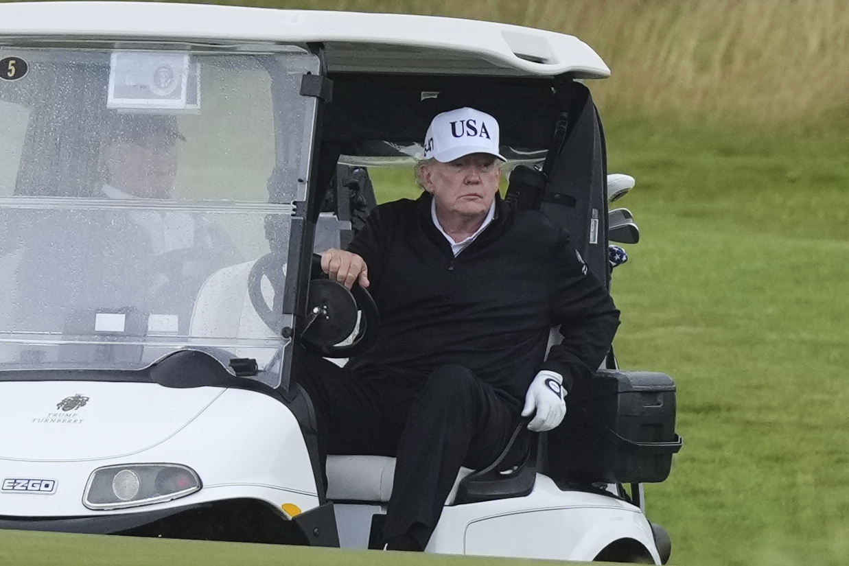 President Donald Trump steers a golf cart at the Trump Turnberry golf course in Turnberry, Scotland, Saturday, July 26, 2025.(AP Photo/Alastair Grant)
