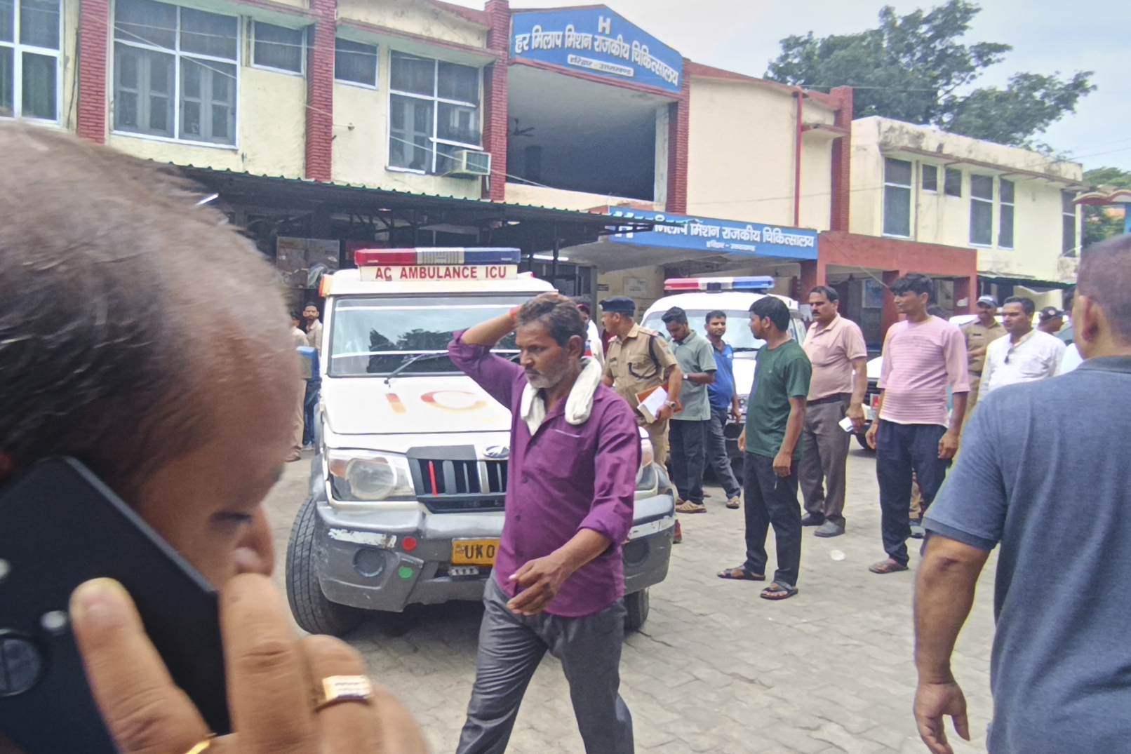 Relatives stand outside a hospital as the injured from temple stampede were brought, in Haridwar, India, Sunday, July 27, 2025. (AP Photo)