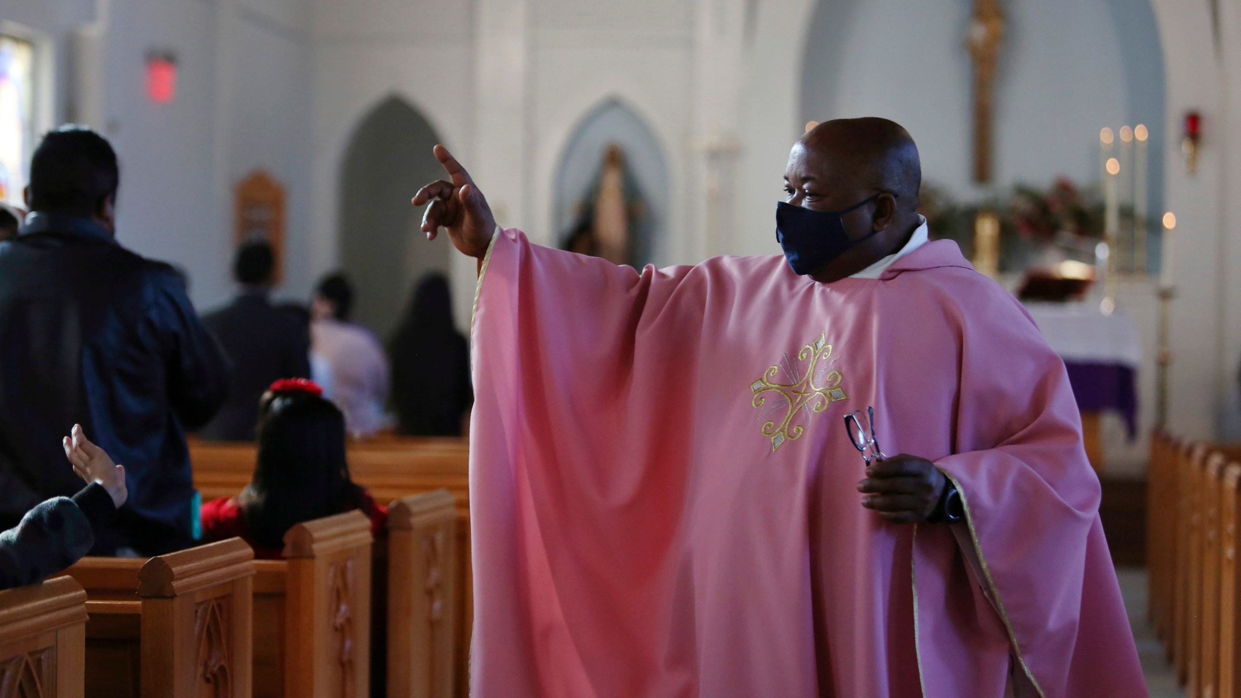 FILE - The Rev. Athanasius Abanulo waves to his parishioners after Mass on Dec. 12, 2021, at Immaculate Conception Catholic Church in Wedowee, Ala. (AP Photo/Jessie Wardarski, File)