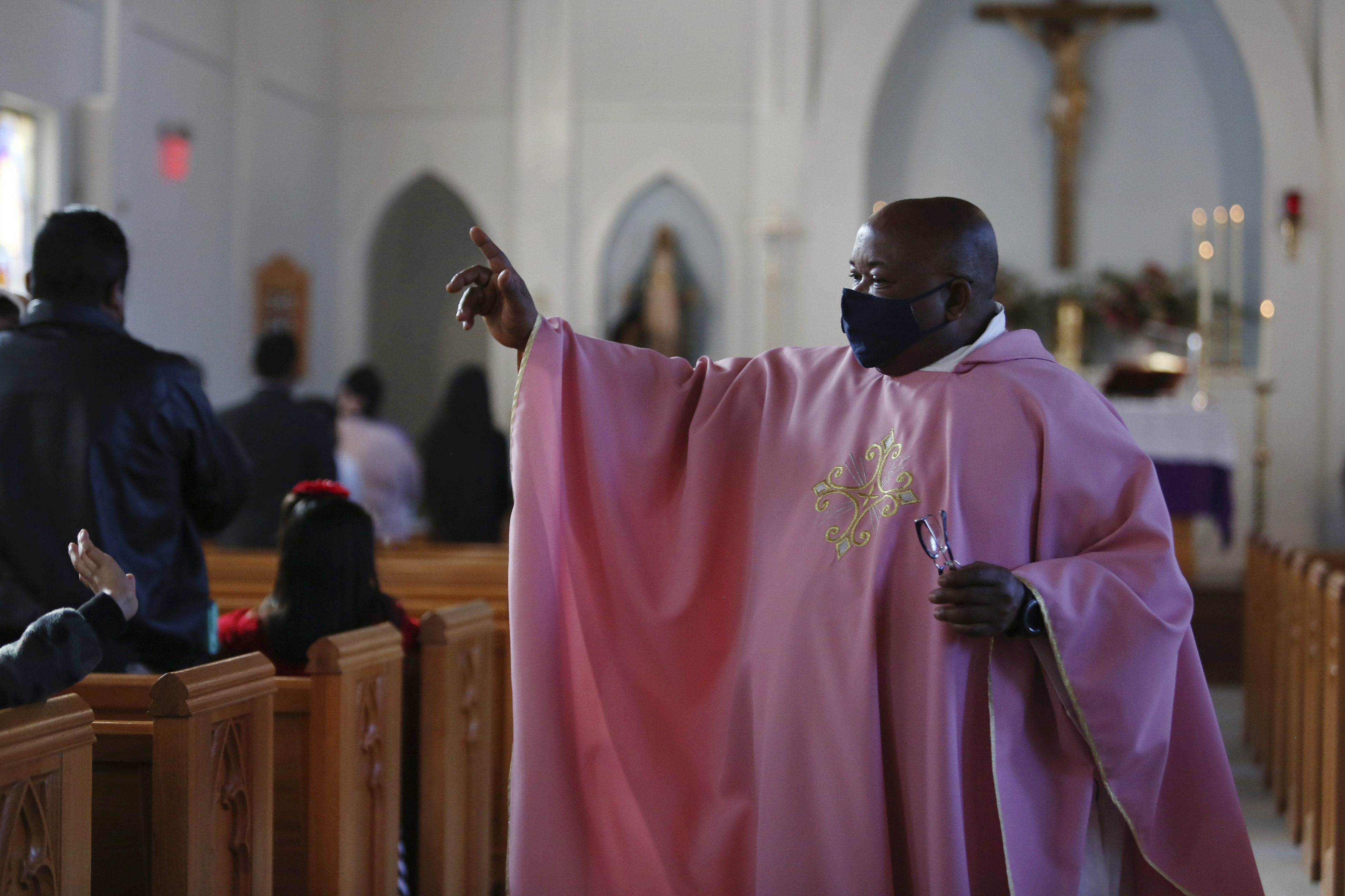 FILE - The Rev. Athanasius Abanulo waves to his parishioners after Mass on Dec. 12, 2021, at Immaculate Conception Catholic Church in Wedowee, Ala. (AP Photo/Jessie Wardarski, File)