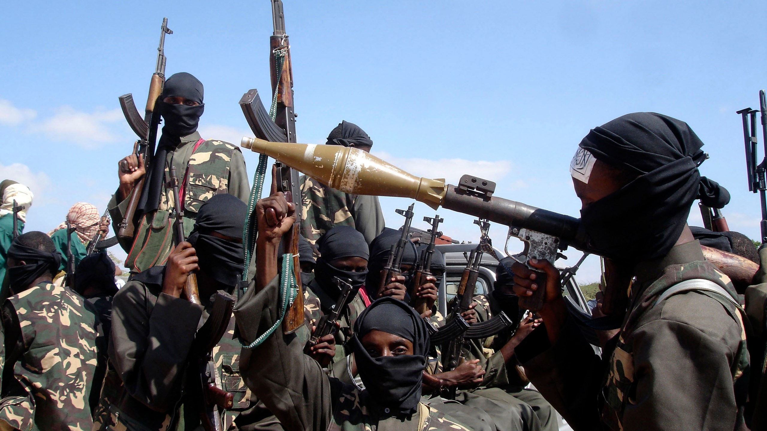 FILE - Armed al-Shabab fighters ride on pickup trucks as they prepare to travel into the city, just outside the capital Mogadishu, in Somalia on Dec. 8, 2008. (AP Photo/Farah Abdi Warsameh, File)