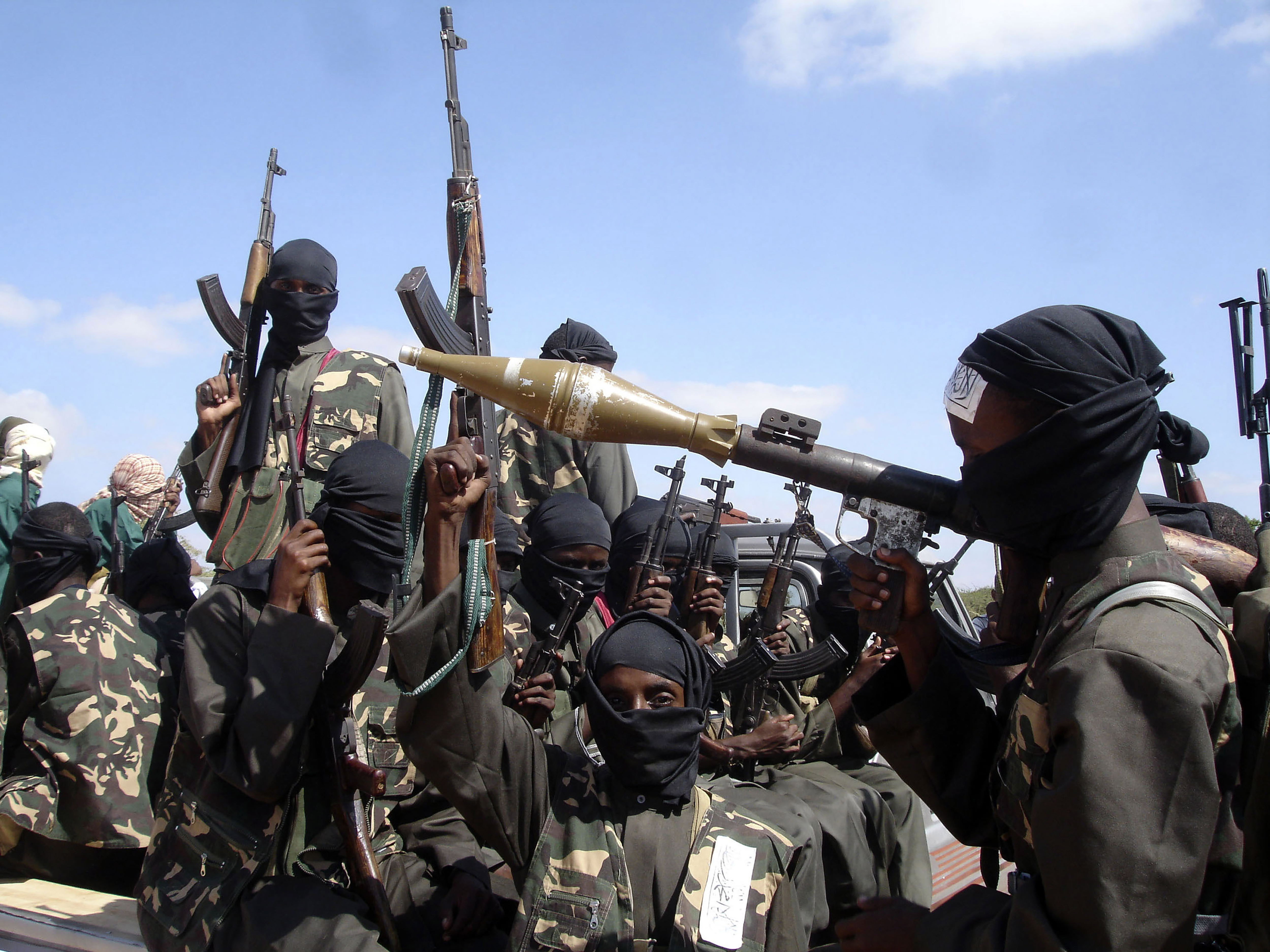 FILE - Armed al-Shabab fighters ride on pickup trucks as they prepare to travel into the city, just outside the capital Mogadishu, in Somalia on Dec. 8, 2008. (AP Photo/Farah Abdi Warsameh, File)
