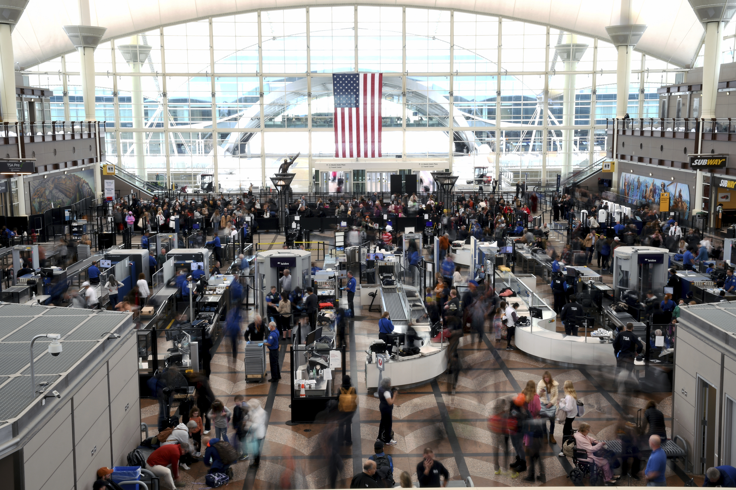 FILE - Passengers wait in a security line at Denver International Airport on Feb. 22, 2023. (AP Photo/Thomas Peipert, File)