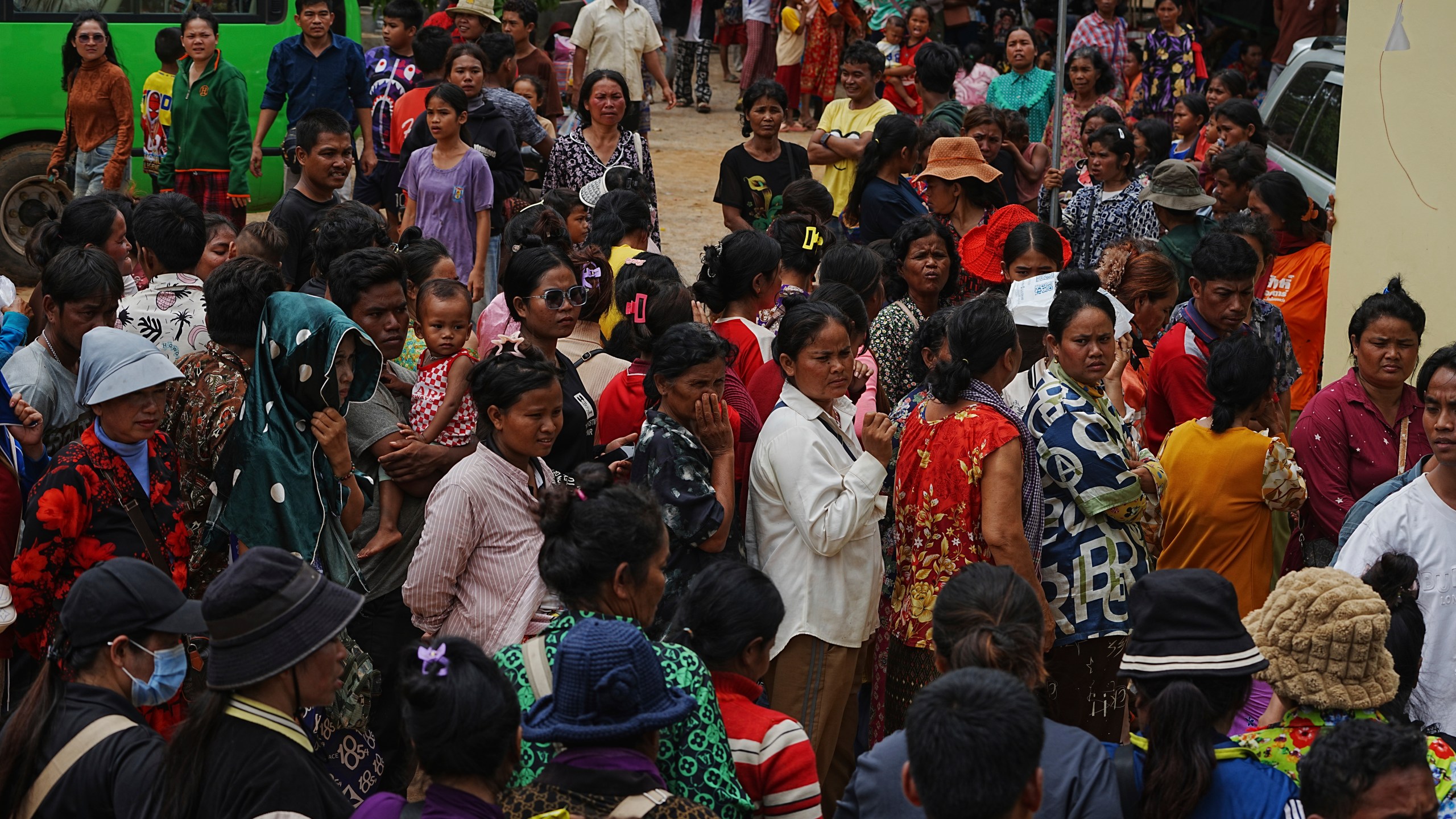 Local villagers wait to receive supplies donated by a charity, in Wat Phnom Kamboar, Oddar Meanchey province, Cambodia, Sunday, July 27, 2025, amid the fighting between Thailand and Cambodia. (AP Photo/Heng Sinith)
