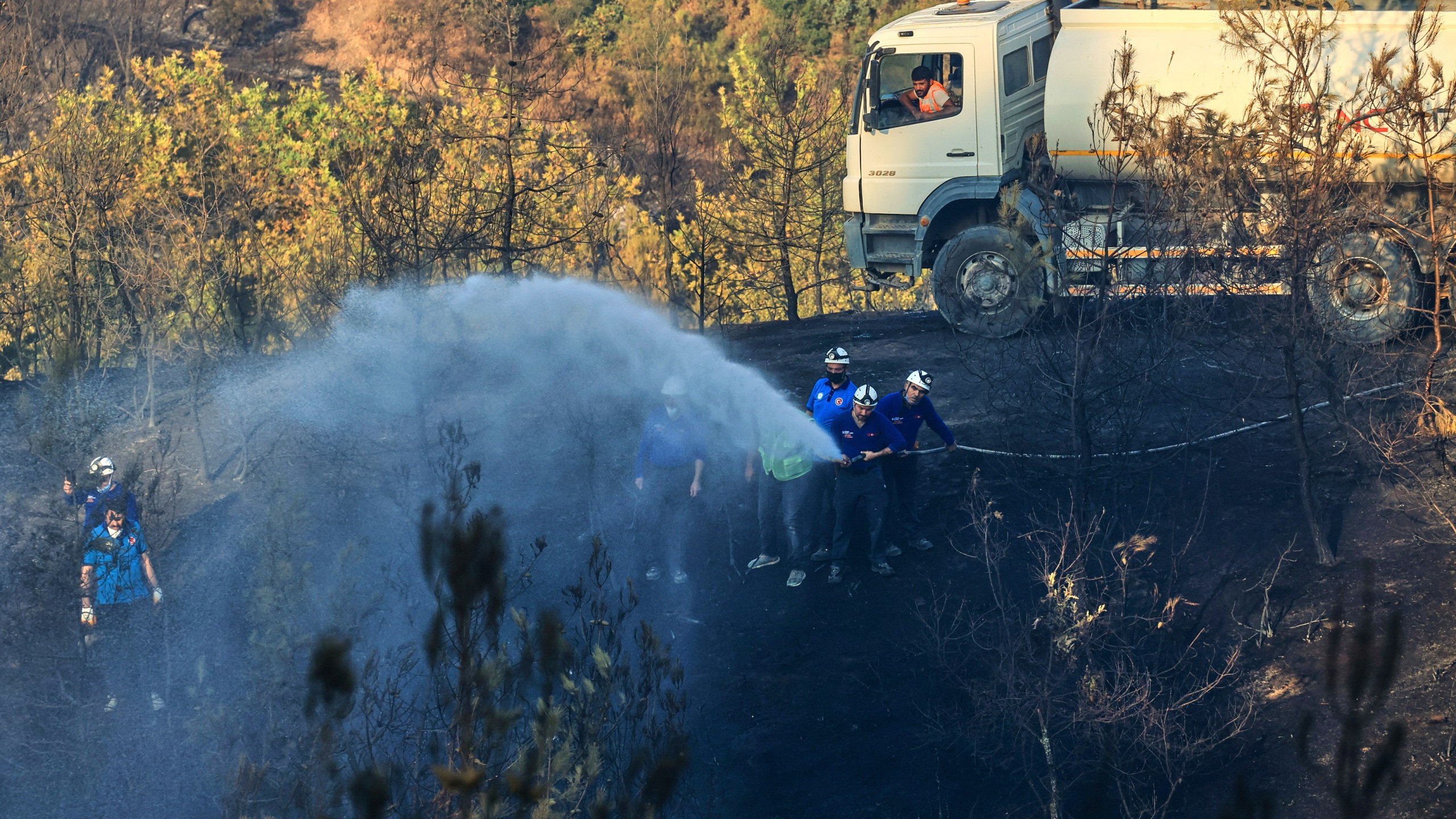 Firefighters work to extinguish a wildfire in Bursa, Turkey, Sunday, July 27, 2025. (Sercan Ozkurnazli/DIA Images via AP)