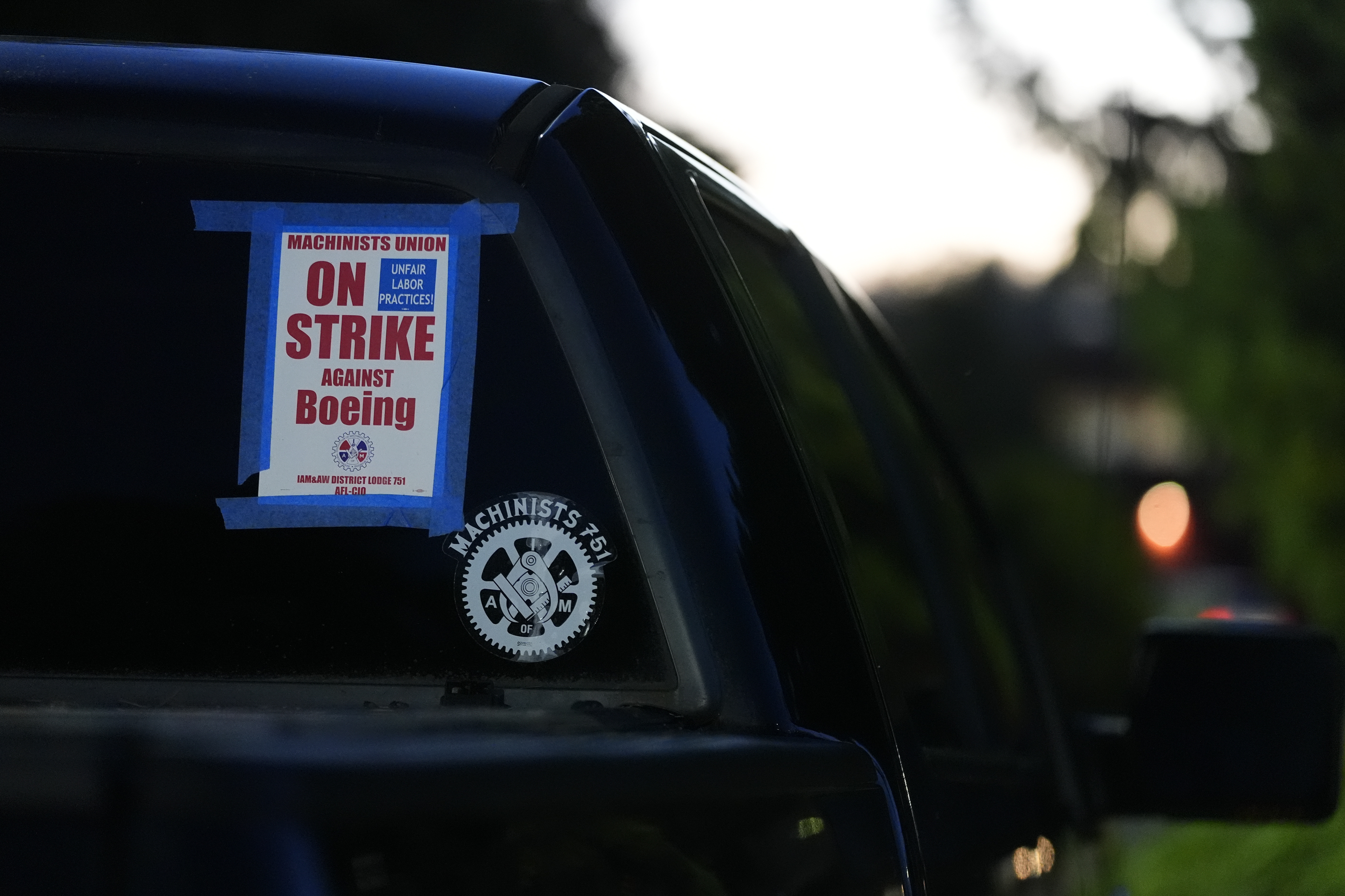FILE - A truck displays a small strike sign in the parking lot of the Aerospace Machinists Union hall as Boeing employees arrive to vote on a new contract offer from the company, Nov. 4, 2024, in Renton, Wash. (AP Photo/Lindsey Wasson, file)