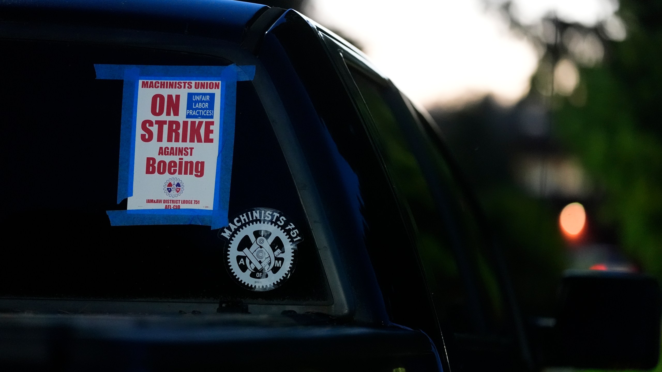 FILE - A truck displays a small strike sign in the parking lot of the Aerospace Machinists Union hall as Boeing employees arrive to vote on a new contract offer from the company, Nov. 4, 2024, in Renton, Wash. (AP Photo/Lindsey Wasson, file)