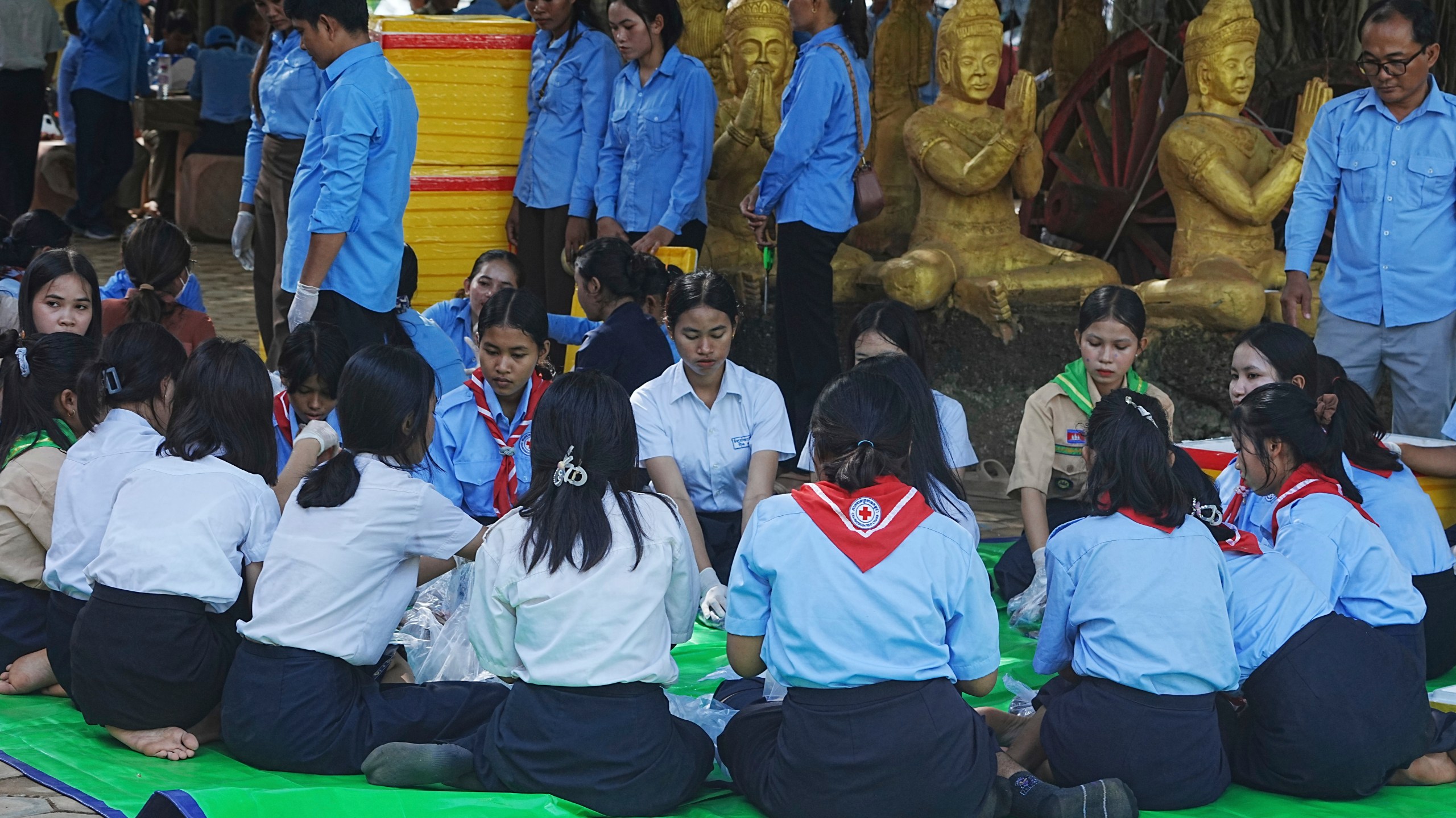 Local students wrap food to give to villagers while they take refuge in Buddhist pagoda in Srey Snam district, Siem Reap province, Cambodia, Sunday, July 28, 2025, amid the fighting between Thailand and Cambodia. (AP Photo/Heng Sinith)