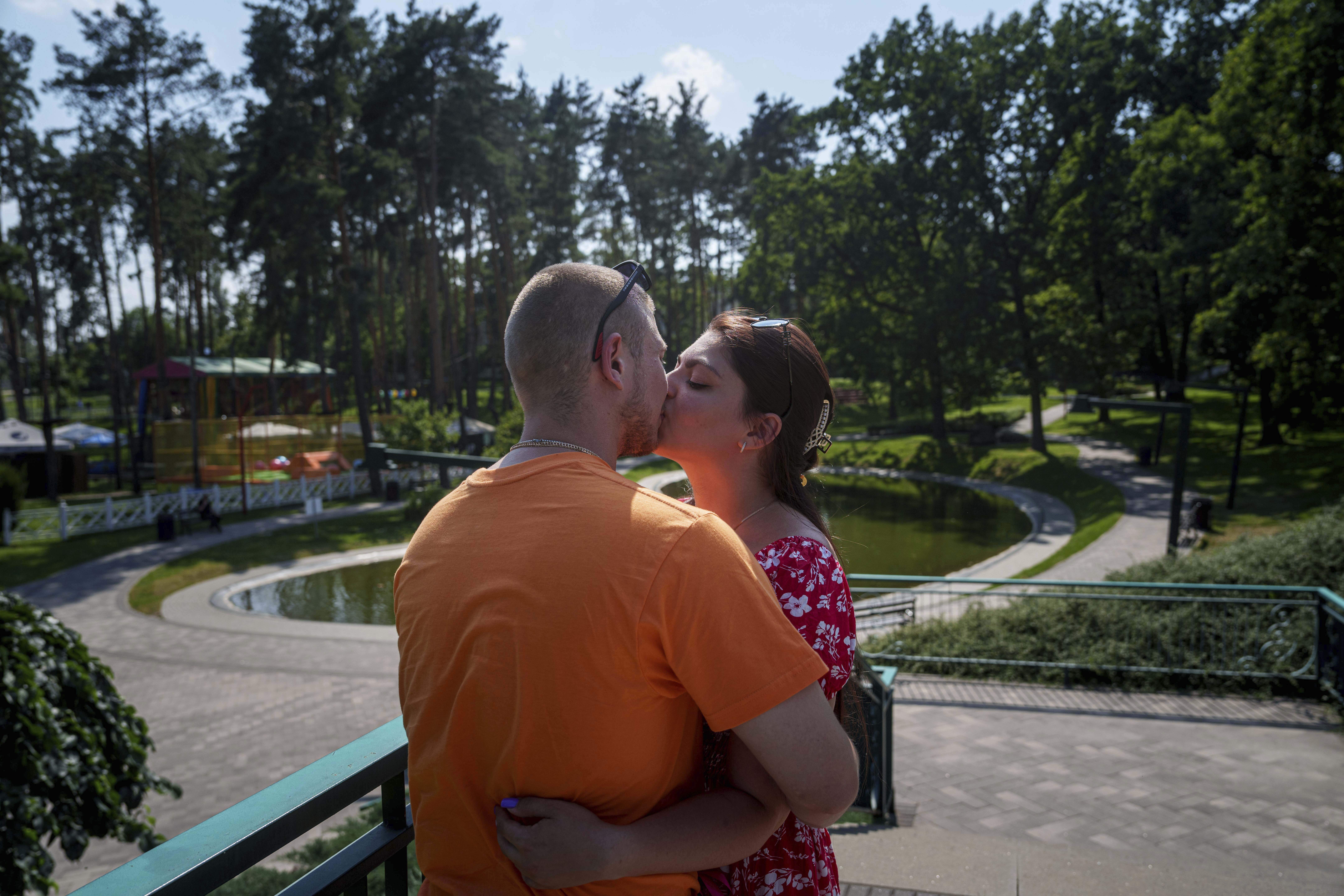 Ukrainian marine Stanislav Tarnavskyi kisses his girlfriend, Tetiana Baieva, in Irpin, Ukraine, Tuesday, July 8, 2025. (AP Photo/Evgeniy Maloletka)