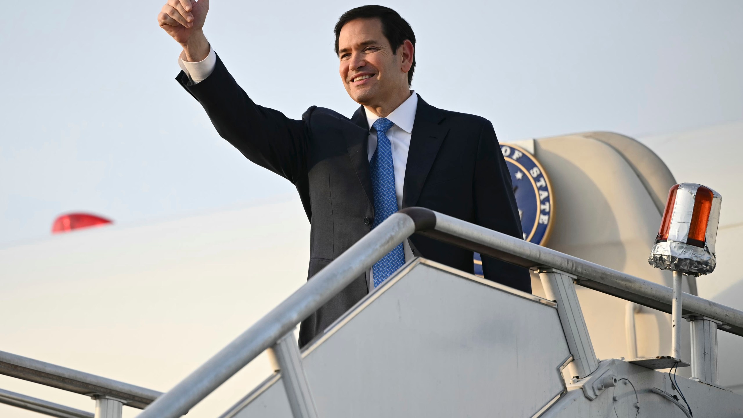 US Secretary of State Marco Rubio gestures as he boards his flight before departing from Subang Air Base, on the outskirts of Kuala Lumpur, on Friday, July 11, 2025, after attending the 58th ASEAN Foreign Ministers' meeting. (Mandel Ngan/Pool Photo via AP)