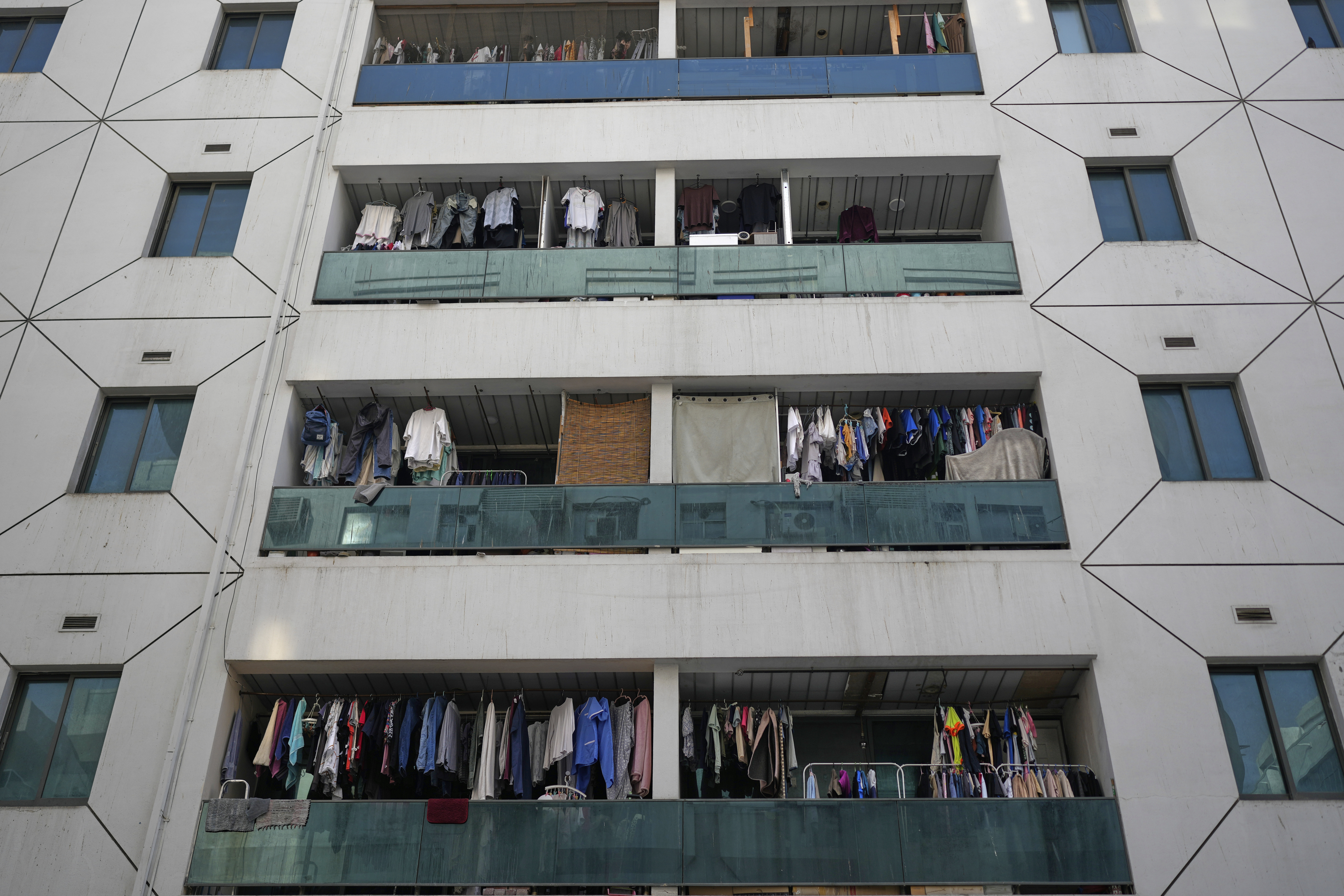 Clothes dry on balconies of a residential building in Dubai, United Arab Emirates, Friday, July 4, 2025. (AP Photo/Altaf Qadri)