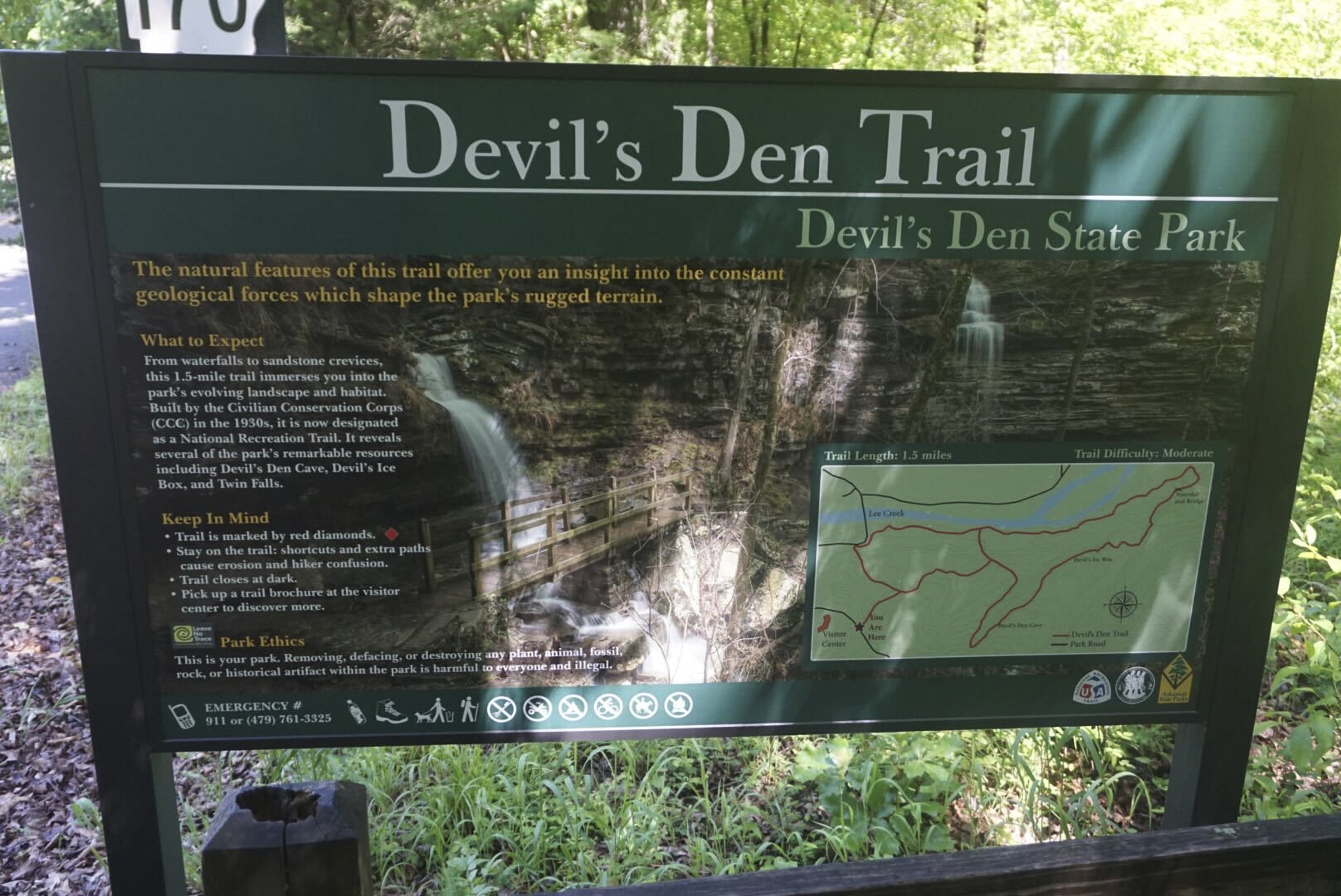 This May 2020 photo provided by Stephen O’Connell shows a sign for a hiking trail at Devil's Den State Park in West Fork, Ark. (Stephen O’Connell via AP)