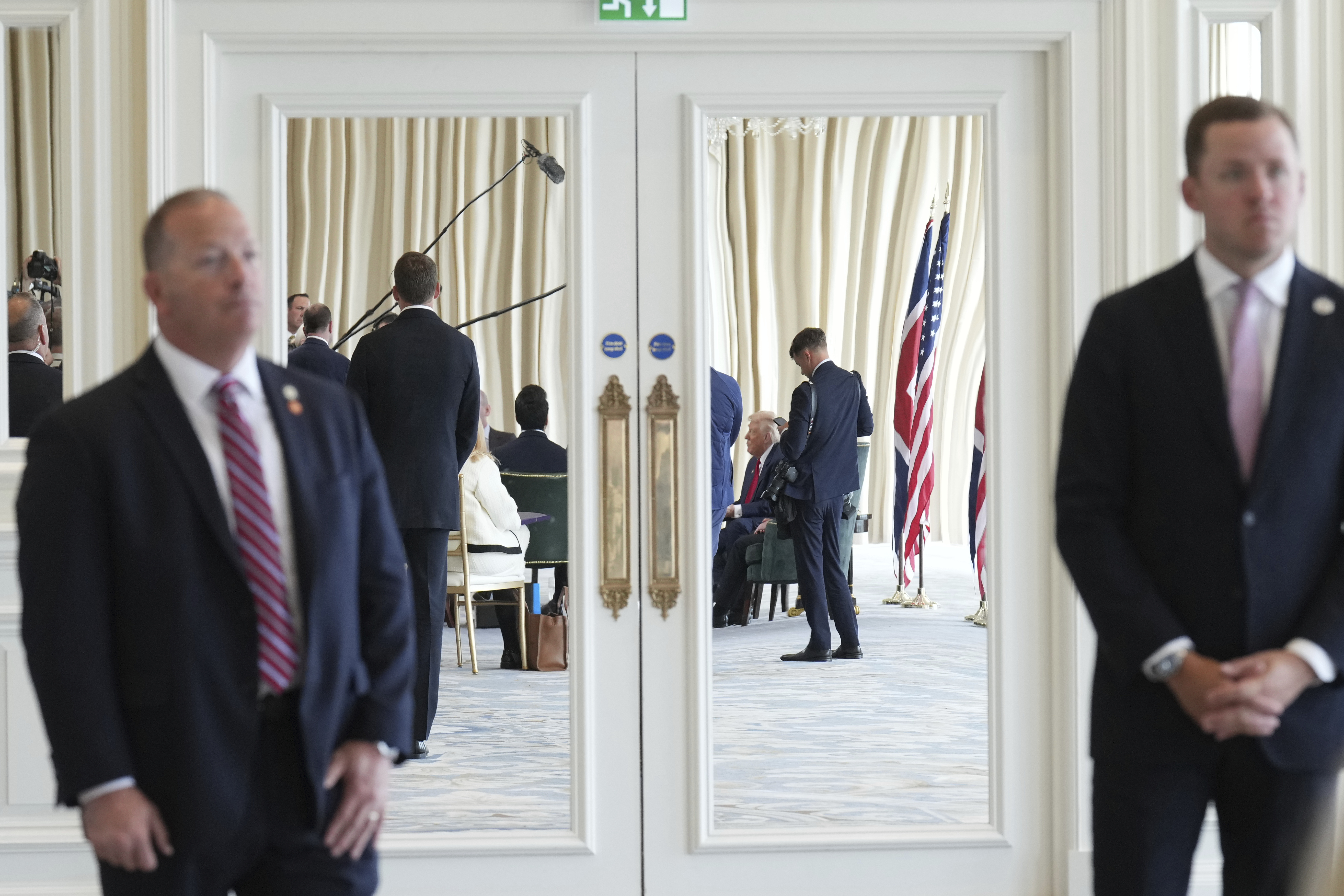 President Donald Trump, background, speaks with the media during a meeting with Britain's Prime Minister Keir Starmer at the Trump Turnberry golf course in Turnberry, Scotland Monday, July 28, 2025. (AP Photo/Jacquelyn Martin)
