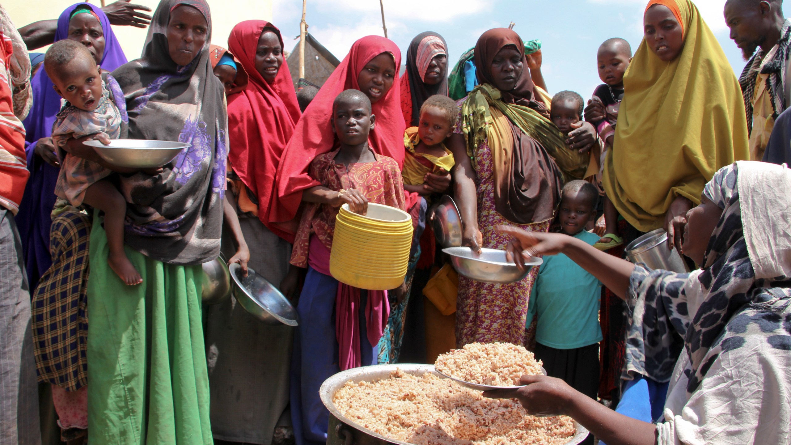 FILE - Newly arrived Somalis, displaced by a drought, receive food distributions at makeshift camps in the Tabelaha area on the outskirts of Mogadishu, Somalia on March 30, 2017. (AP Photo/Farah Abdi Warsameh, File)