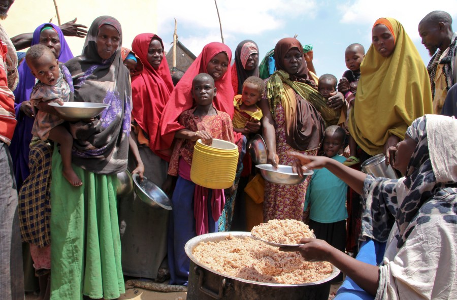 FILE - Newly arrived Somalis, displaced by a drought, receive food distributions at makeshift camps in the Tabelaha area on the outskirts of Mogadishu, Somalia on March 30, 2017. (AP Photo/Farah Abdi Warsameh, File)