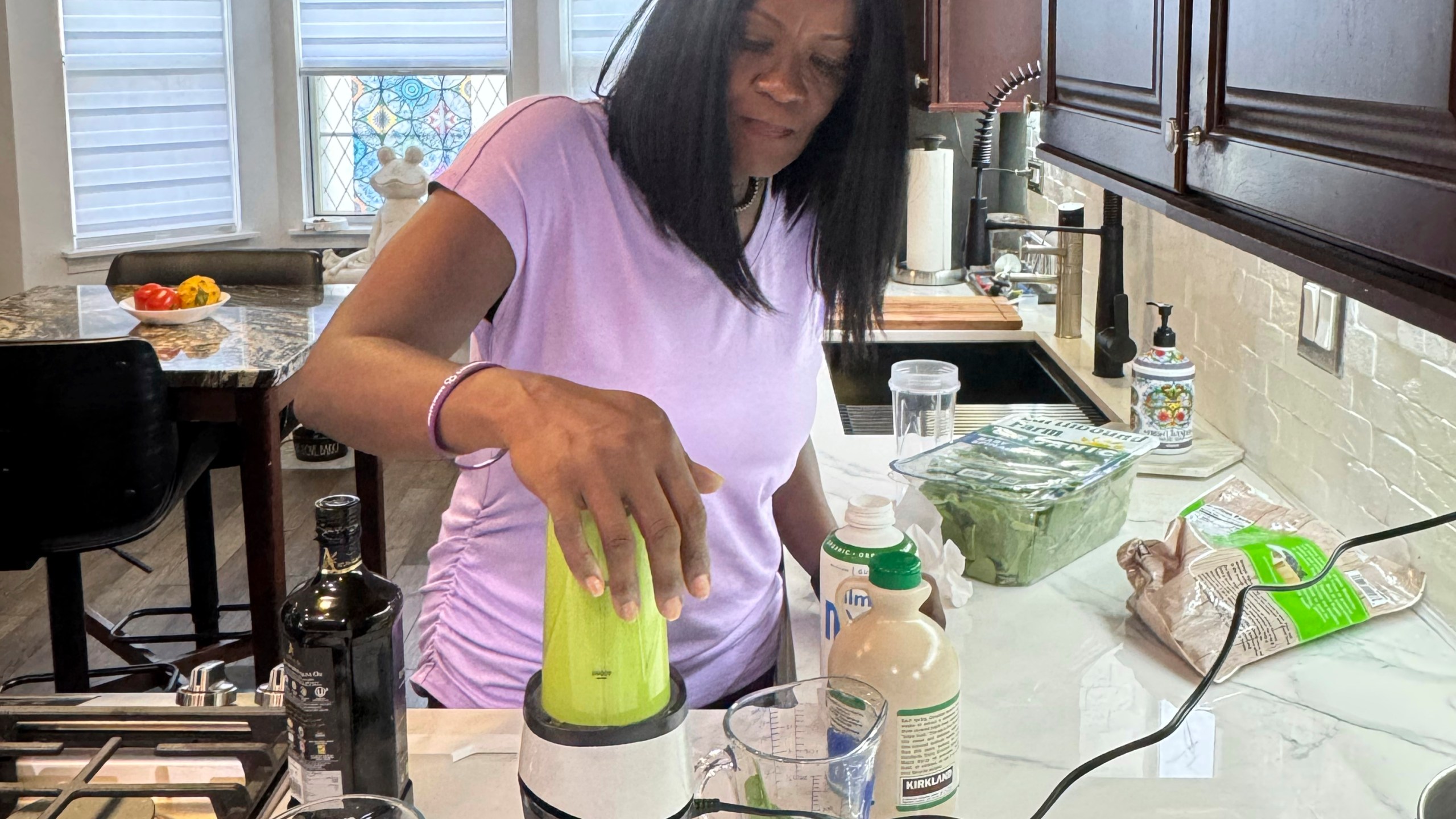 In this photo provided by Phyllis Jones, she prepares a smoothie with spinach, frozen blueberries, almond milk with pumpkin spice and date sugar at home in Aurora, Ill., on Friday, July 25, 2025. (Courtesy Phyllis Jones via AP)
