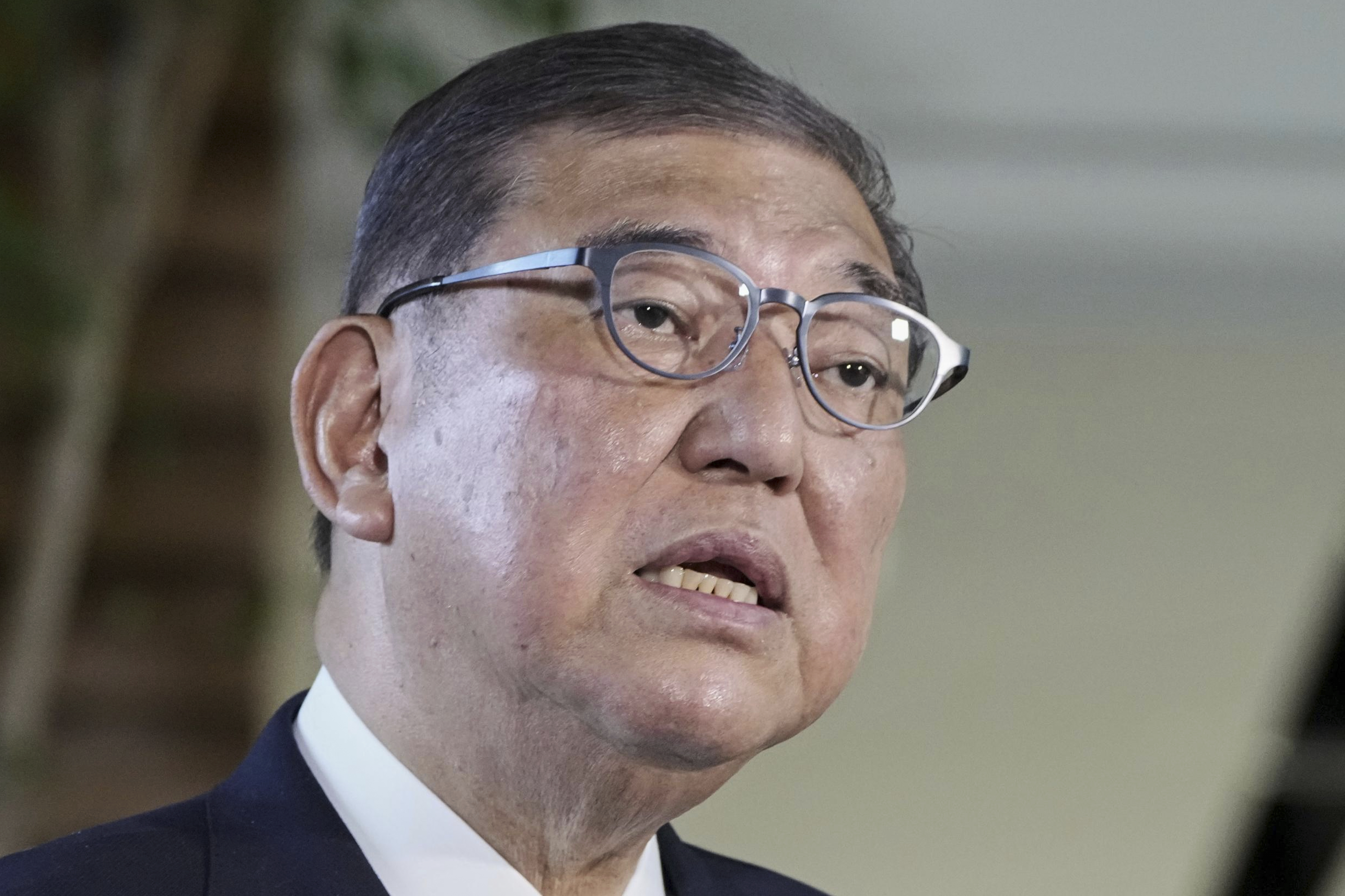 Japanese Prime Minister Shigeru Ishiba speaks to the media as President Donald Trump announced a trade framework with Japan, at the prime minister's office in Tokyo, Japan, Wednesday, July 23, 2025. (Kyodo News via AP)