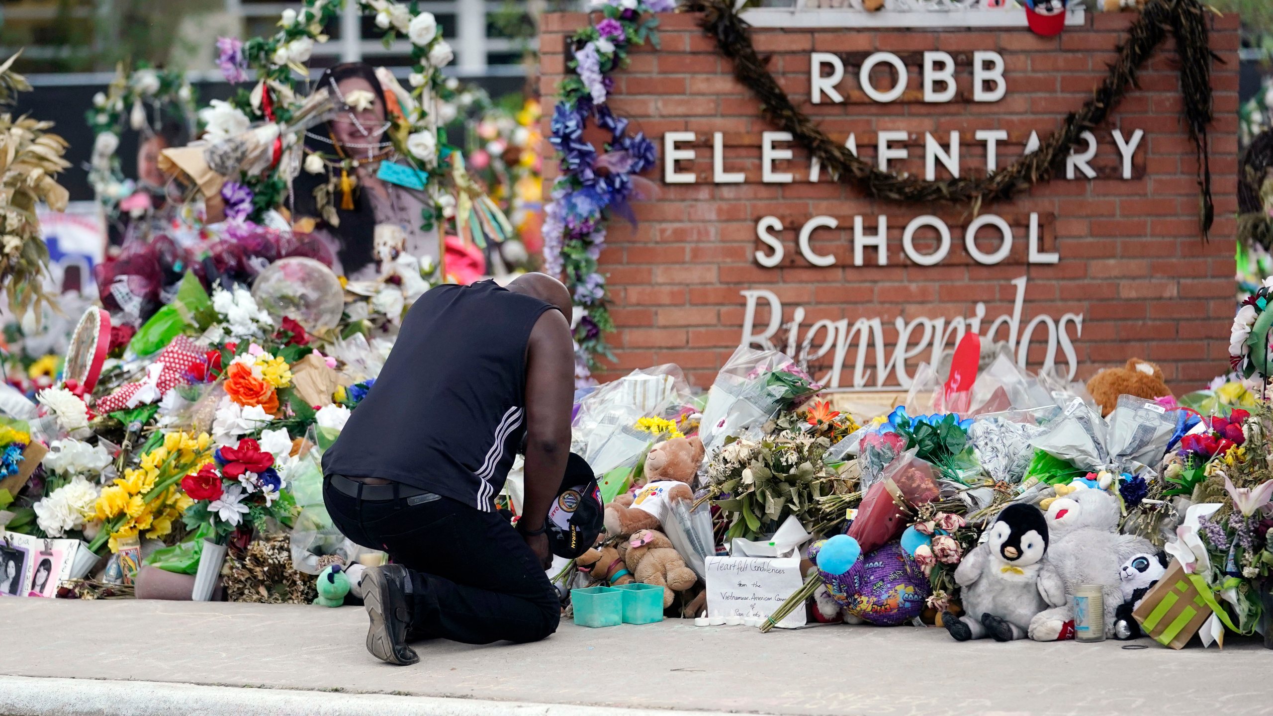 FILE - Reggie Daniels pays his respects a memorial at Robb Elementary School, Thursday, June 9, 2022, in Uvalde, Texas, created to honor the victims killed in the recent school shooting. (AP Photo/Eric Gay, file)
