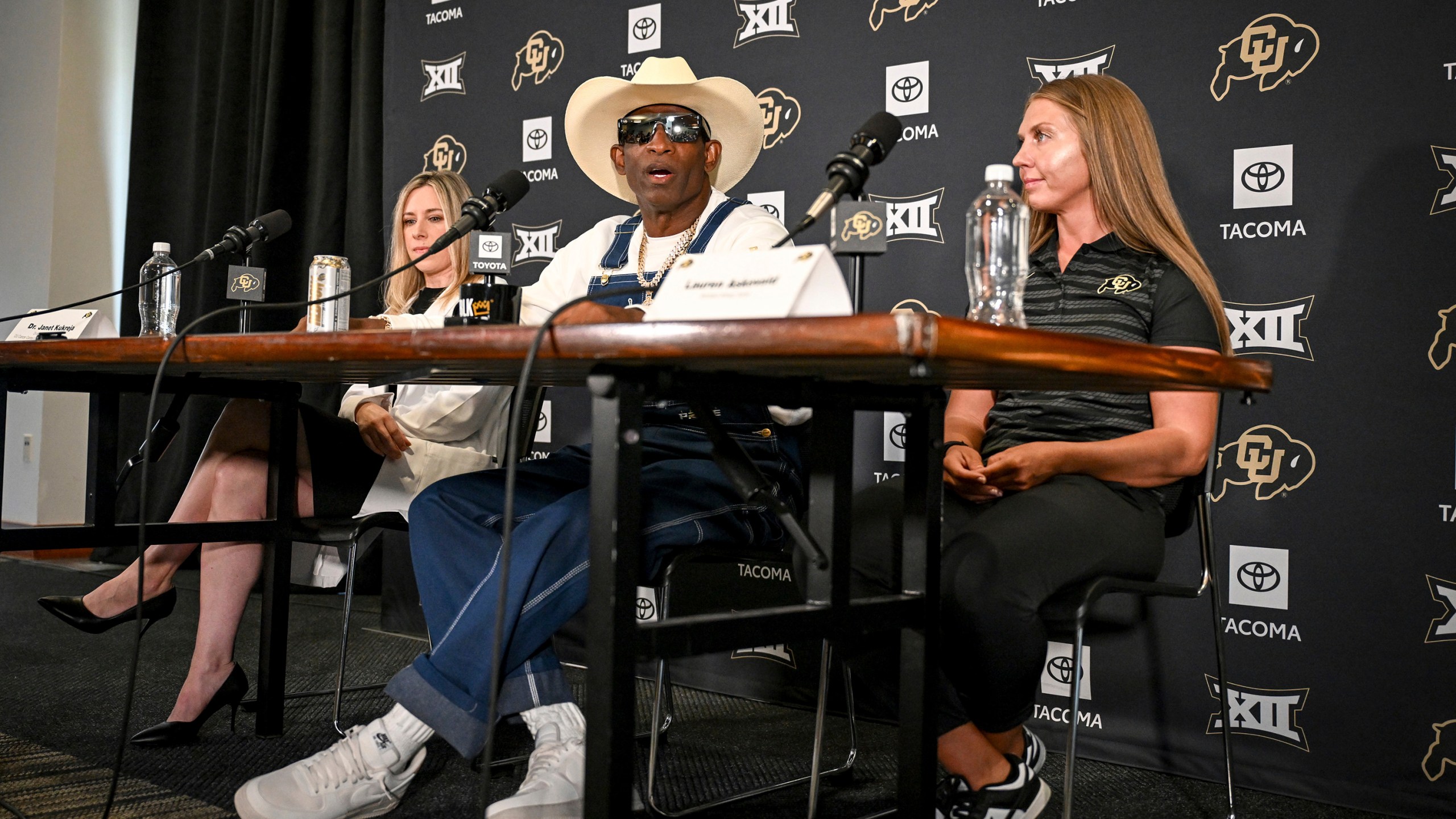 Colorado head coach DeIon Sanders, center, speaks beating bladder cancer during a news conference Monday, July 28, 2025, in Boulder, Colo. (AAron Ontiveroz/The Denver Post via AP)