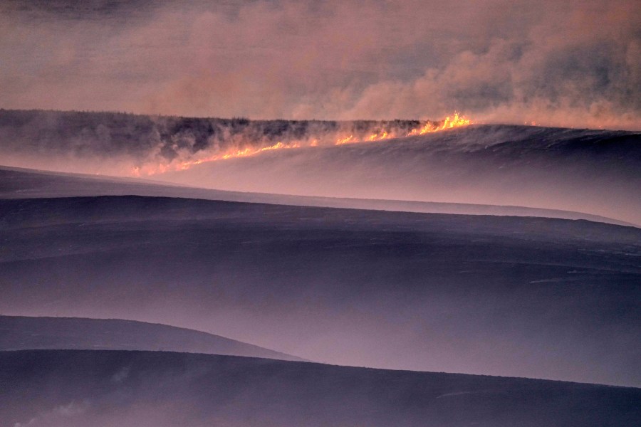 FILE- Wind fueled fires burn in a pasture which was part of a fire that burned and stretched across Ellis, Russell, Osborne and Rooks counties, Dec. 16, 2021, near Natoma, Kan. (AP Photo/Charlie Riedel, file)