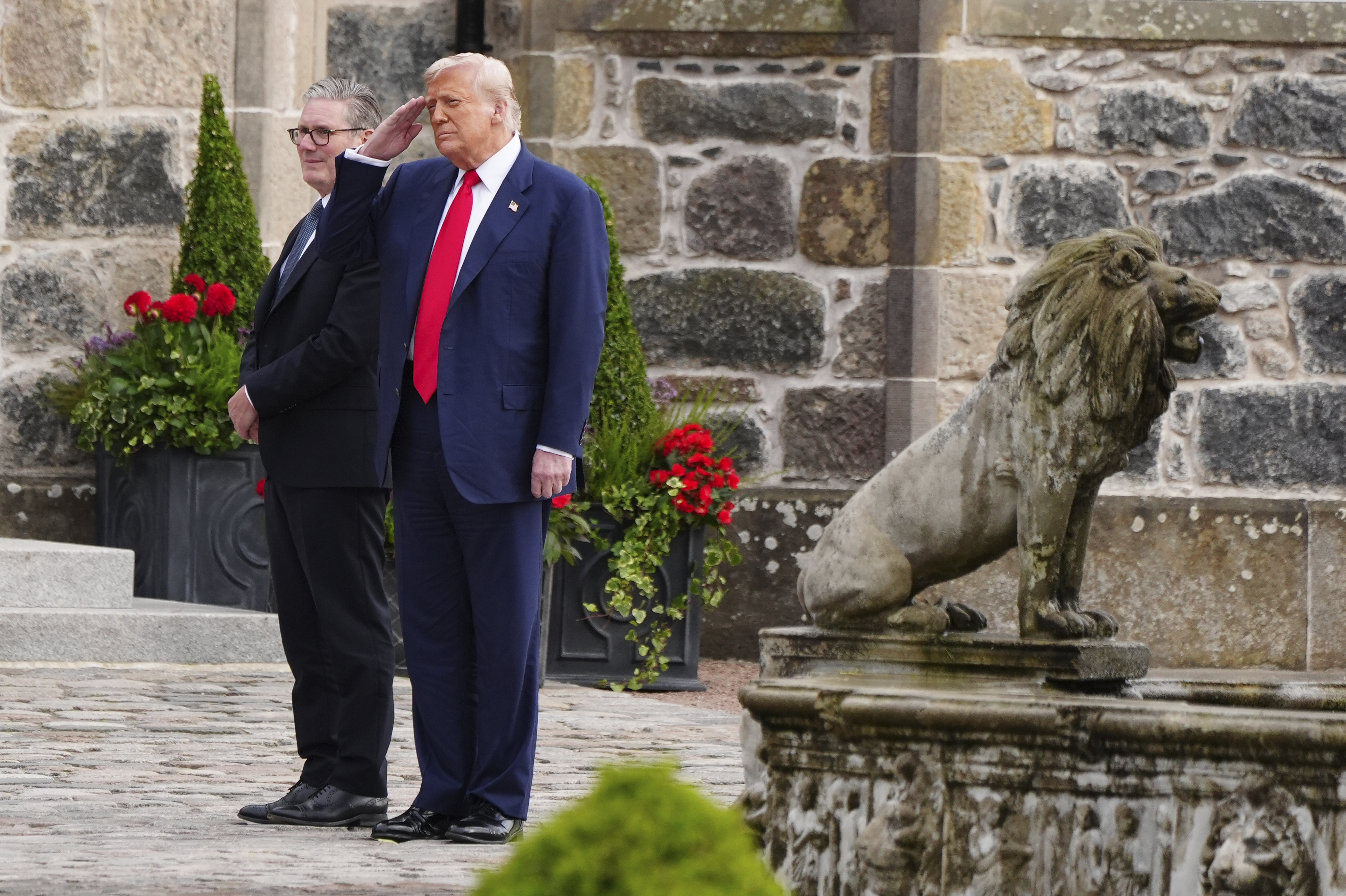 U.S. President Donald Trump, right, and British Prime Minister Keir Starmer walk at Trump International Golf Links in Aberdeenshire, Scotland, Monday, July 28, 2025. (Jane Barlow/Pool Photo via AP)